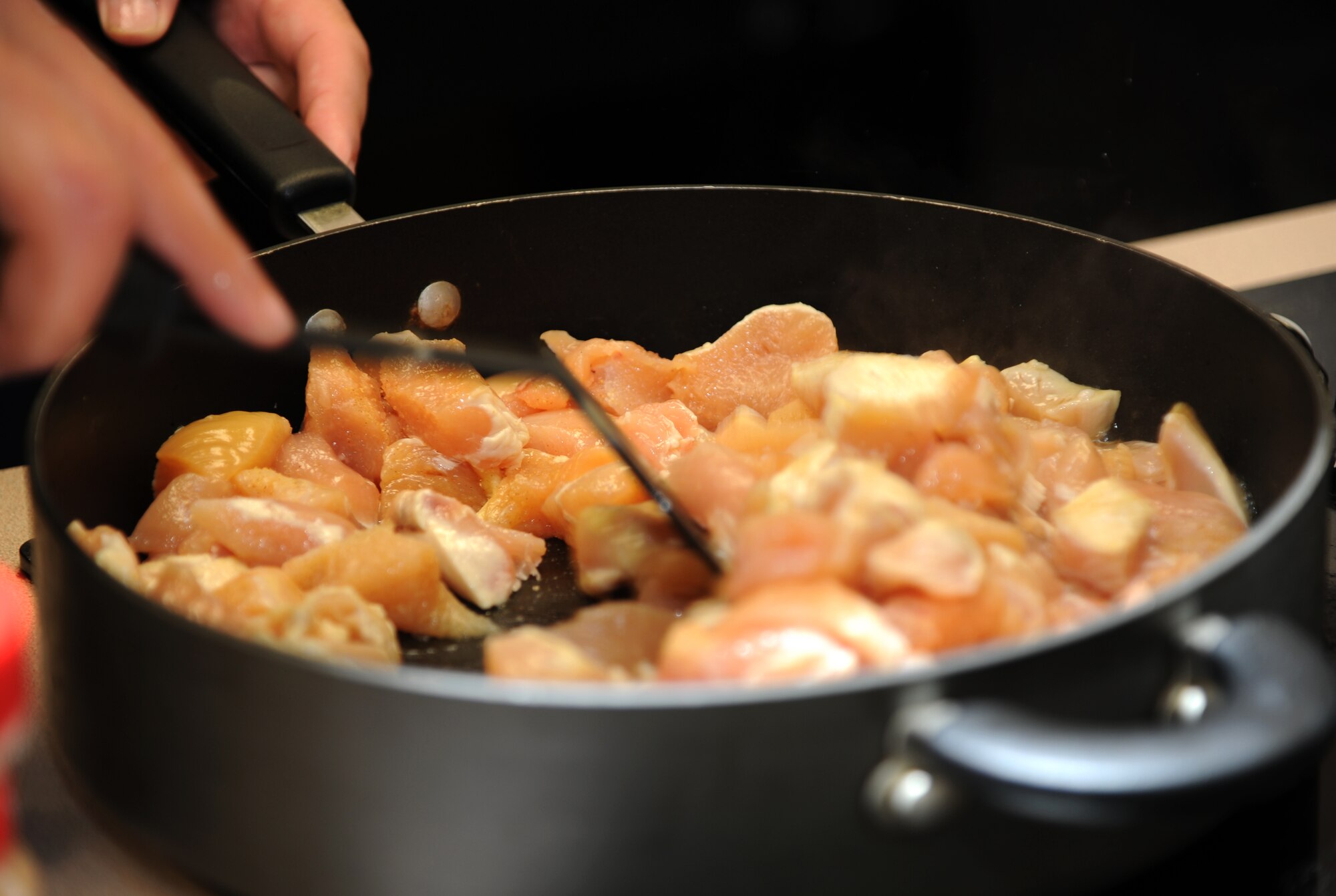 Sautéed chicken awaits vegetables and spices during the first of six cooking classes held March 12 in the Health and Wellness Center at Vance Air Force Base, Okla. (U.S. Air Force photo/ Airman 1st Class Frank John Casciotta)