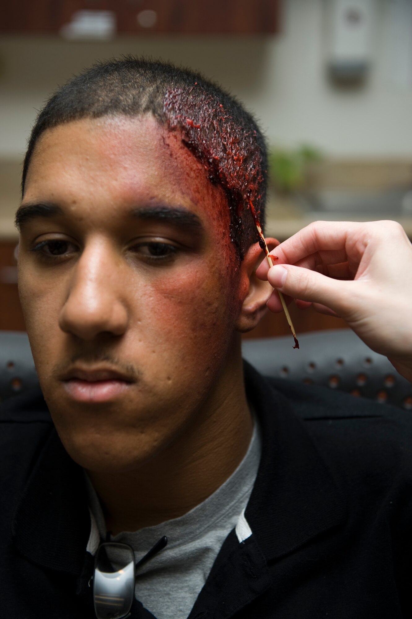 BUCKLEY AIR FORCE BASE, Colo. -- Airman 1st Class Taquan Kelly, 460th Civil Engineer Squadron receives moulage in preparation for an upcoming exercise scenario March 12, 2012.  This exercise is one of many Buckley is using to prepare for an upcoming inspection.  (U.S. Air Force photo by Airman 1st Class Phillip Houk)