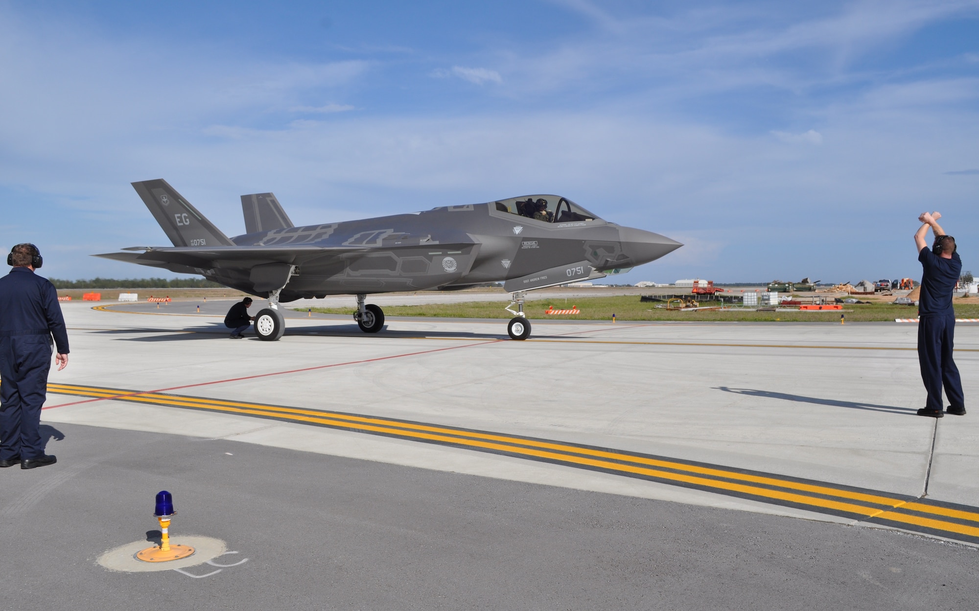 EGLIN AIR FORCE BASE, Fla. -- Contracted Logistics Maintenance personnel from Lockheed Martin at Eglin Air Force Base, Fla., stop the pilot on the taxiway during the return of his flight in preparation to verify the F-35A’s brake temperatures are within safe limits to recover the aircraft March 13. An electronic hand-held device takes an immediate temperature reading. This procedure is what is commonly dubbed by crew chiefs and pilots as the “hot brake check.” The Air Force variant of the joint strike fighter is piloted by Marine Corps Maj. Joseph Bachmann, and this cross-service cooperation is a hallmark of the Joint Strike Fighter Integrated Training Center located at the 33rd Fighter Wing at Eglin AFB. (U.S. Air Force photo/Maj. Karen Roganov)