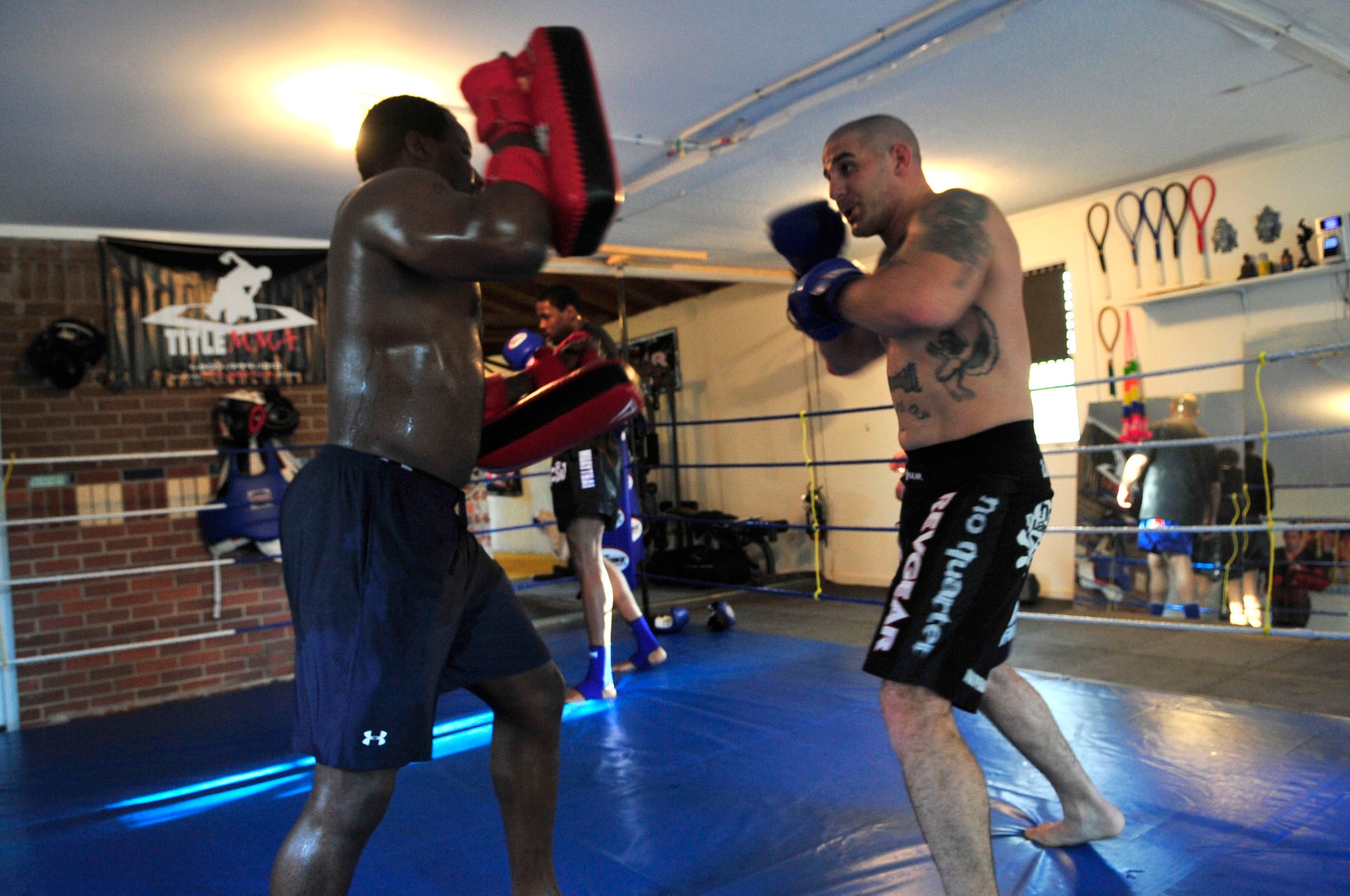 COLUMBIA - Mix martial arts heavyweight Adrian Henderson (left), a native of Columbia, S.C. practices mix martial arts with U.S. Air Force Staff Sgt. Ferdinando Acerra, a maintenance training instructor assigned to the 20th Medical Operations Squadron, 20th Fighter Wing, Shaw Air Force Base, S.C. while at the Sor Sumrit Muay Thai Gym in Columbia, S.C. on March 13, 2012. Acerra, along with two others from his gym will compete in matches at Shaw AFB's first ever MMA event on March 30, 2012. (U.S.  Air Force photo/Master Sgt. Cohen A. Young/Released)