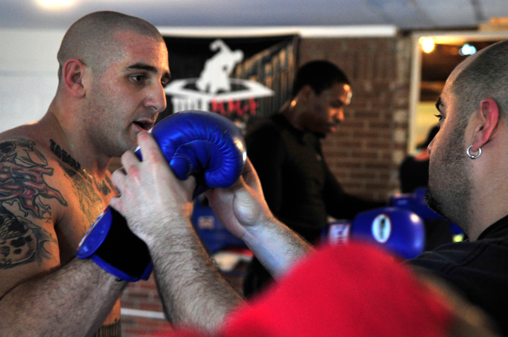COLUMBIA - U.S. Air Force Staff Sgt. Ferdinando Acerra (left), a maintenance training instructor assigned to the 20th Medical Operations Squadron, 20th Fighter Wing, Shaw Air Force Base, S.C. listens to Nick Rodriguez about mix martial arts strategies while at the Sor Sumrit Muay Thai Gym in Columbia, S.C. on March 13, 2012. Acerra, along with two others from the gym will compete in matches at Shaw AFB's first ever MMA event on March 30, 2012. (U.S.  Air Force photo/Master Sgt. Cohen A. Young/Released)