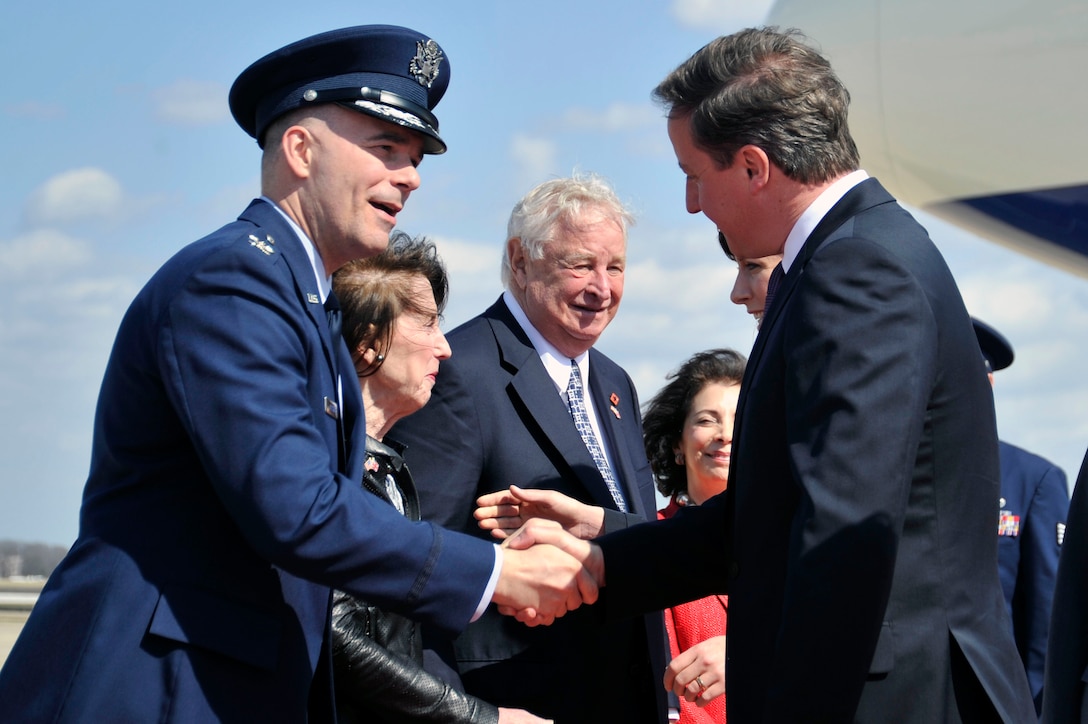 Col. Mark Allison, 11th Wing staff judge advocate, greets British Prime Minister David Cameron as he steps off his plane and onto the Joint Base Andrews, Md., flightline March 13. (U.S. Air Force photo/Senior Airman Perry Aston)