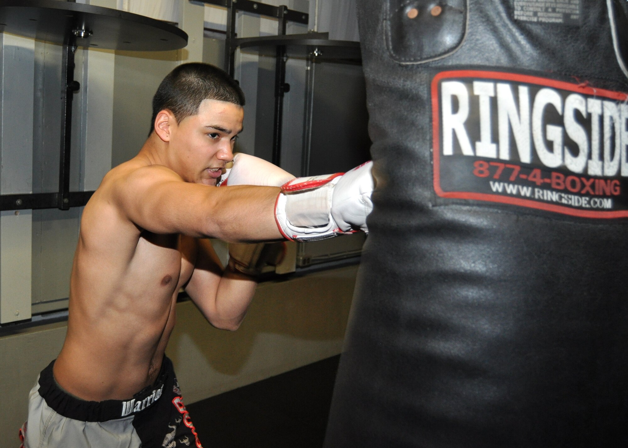 Airman 1st Class Armando Gonzalez, 81st Medical Operations Squadron,  demonstrates his mixed martial arts form Feb 21, 2012, at the Triangle Fitness Center Keesler Air Force Base, Miss. Gonzalez has been practicing MMA for three years and balances daily practice with duty and education.  (U.S. Air Force photo by Steve Pivnick)