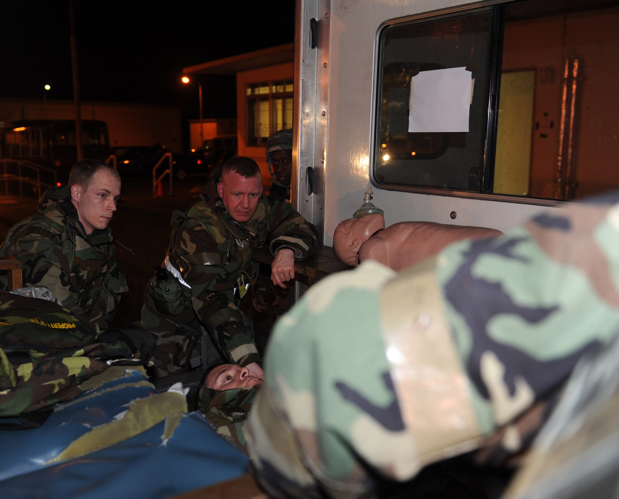U.S. Air Force Maj. Christopher Smith, 18th Aircraft Maintenance Squadron maintenance operations officer, and Staff Sgt. Michael Wixom, 18th Medical Operations Squadron independent duty medical technician, prepare to pull Master  Sgt. Thomas Smith, 18th Aircraft Maintenance Squadron production superintendent from the ambulance during local operational readiness exercise Beverly High 12-3 on Kadena Air Base, Japan, March 14, 2012. Kadena is participating in a LORE to prepare Airmen for future contingencies. (U.S. Air Force photo by Airman 1st Class Justin Veazie/released)