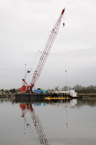 Contractors work at cutting and preparing section of Pier Charlie to be lifted by crane at Joint Base Charleston-Weapons Station, March 13. Pier Charlie is being demolished as part of a program to remove excess infrastructures. Once Pier Charlie is dismantled, workers will build a smaller pier to allow Harbor Patrol Units access to the 628th Logistics Readiness Squadron Port Operations Facility.  (U.S. Navy photo/Petty Officer 1st Class Jennifer Hudson)