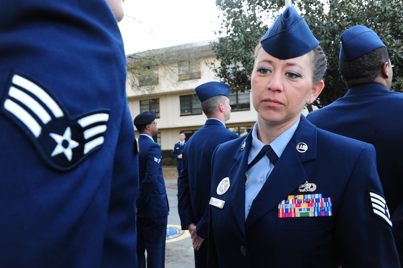 Staff Sgt. Patti Jones inspects a student's dress uniform during Airman Leadership School at Joint Base Charleston - Air Base Mar. 5.  Jones is a 628th Force Support Squadron ALS instructor. (U.S. Air Force photo/Staff Sgt. Katie Gieratz)

