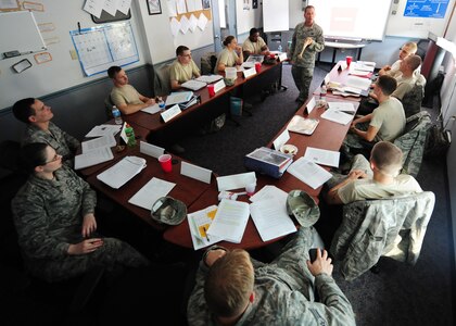 Technical Sgt. Brandon Hutchins answers questions from Airmen Leadership School students in the ALS flight room at Joint Base Charleston - Air Base Mar. 2. The six-week ALS course instructs students on effective communication, group dynamics, team building and leadership. Hutchins is the ALS non-commissioned officer in charge. (U.S. Air Force photo/Staff Sgt. Katie Gieratz)
