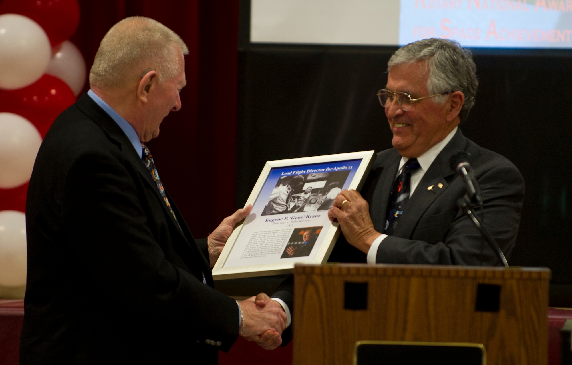 ALAMOGORDO, N.M. – Mr. Gene Kranz, flight director of the odd-numbered Apollo missions, receives an award from Mr. Harrison Schmitt, an astronaut on the Apollo 16 mission, March 10. Kranz came to Alamogordo to revisit Holloman and be inducted into the International Space Hall of Fame. (U.S. Air Force photo by Airman 1st Class Michael Shoemaker/Released)