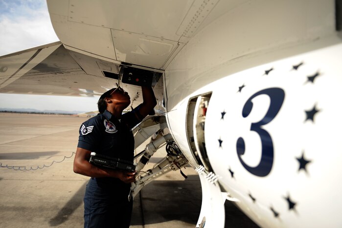 Staff Sgt. Tacota LeMuel, Thunderbird 3 dedicated crew chief, inspects the inside of a panel on her jet during a post-flight inspection at Nellis Air Force Base, Nev., March 12, 2012.(U.S. Air Force photo/Staff Sgt. Larry E. Reid Jr., Released)