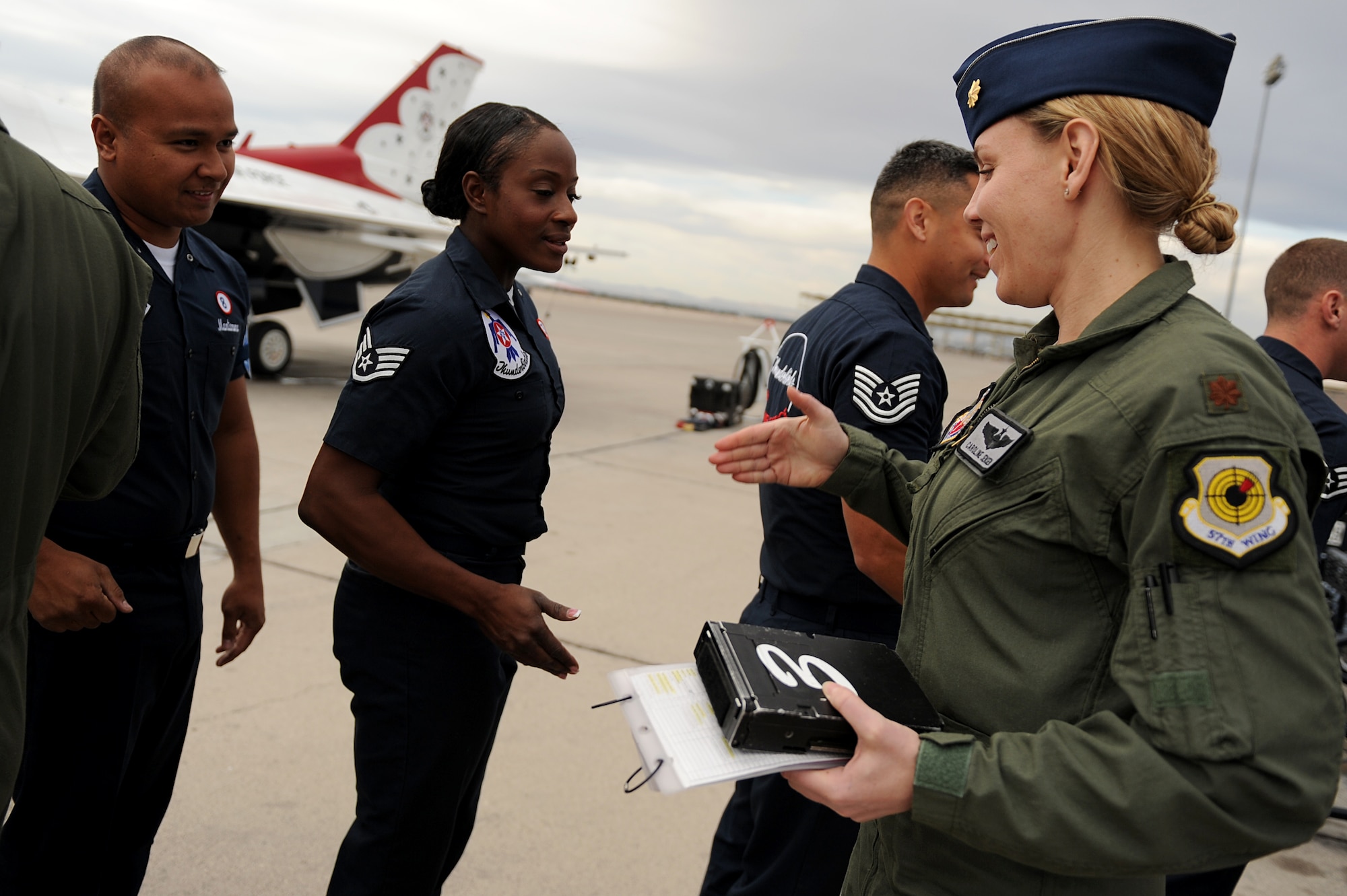 Maj. Caroline Jensen, Thunderbird 3, Right Wing pilot, is greeted by her dedicated crew chief, Staff Sgt. Tacota LeMuel, on the flightline at Nellis Air Force Base, Nev., March 12, 2012.
(U.S. Air Force photo/Staff Sgt. Larry E. Reid Jr., Released)