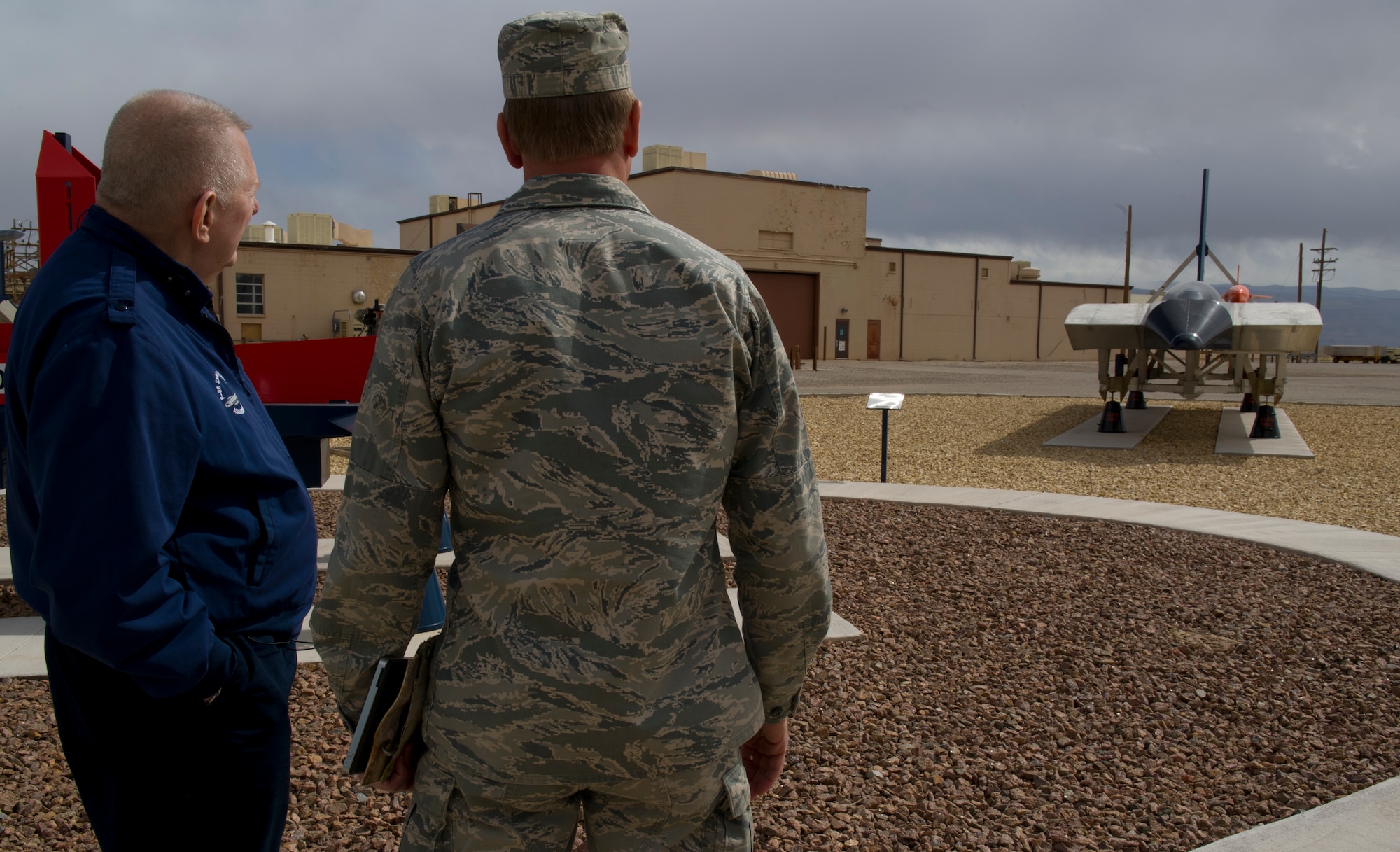 HOLLOMAN AIR FORCE BASE, N.M. – Mr. Gene Kranz, flight director of the odd-numbered Apollo missions, and Lt. Col. David Dunn, 846th Test Squadron commander, observe displays of test track sleds at the 46th Test Group March 8. In the past Kranz worked at Holloman AFB with the McDonnell Aircraft Corporation, where he assisted with the research and testing of new Surface-to-Air and Air-to-Ground missiles. (U.S. Air Force photo by Airman 1st Class Michael Shoemaker/Released)