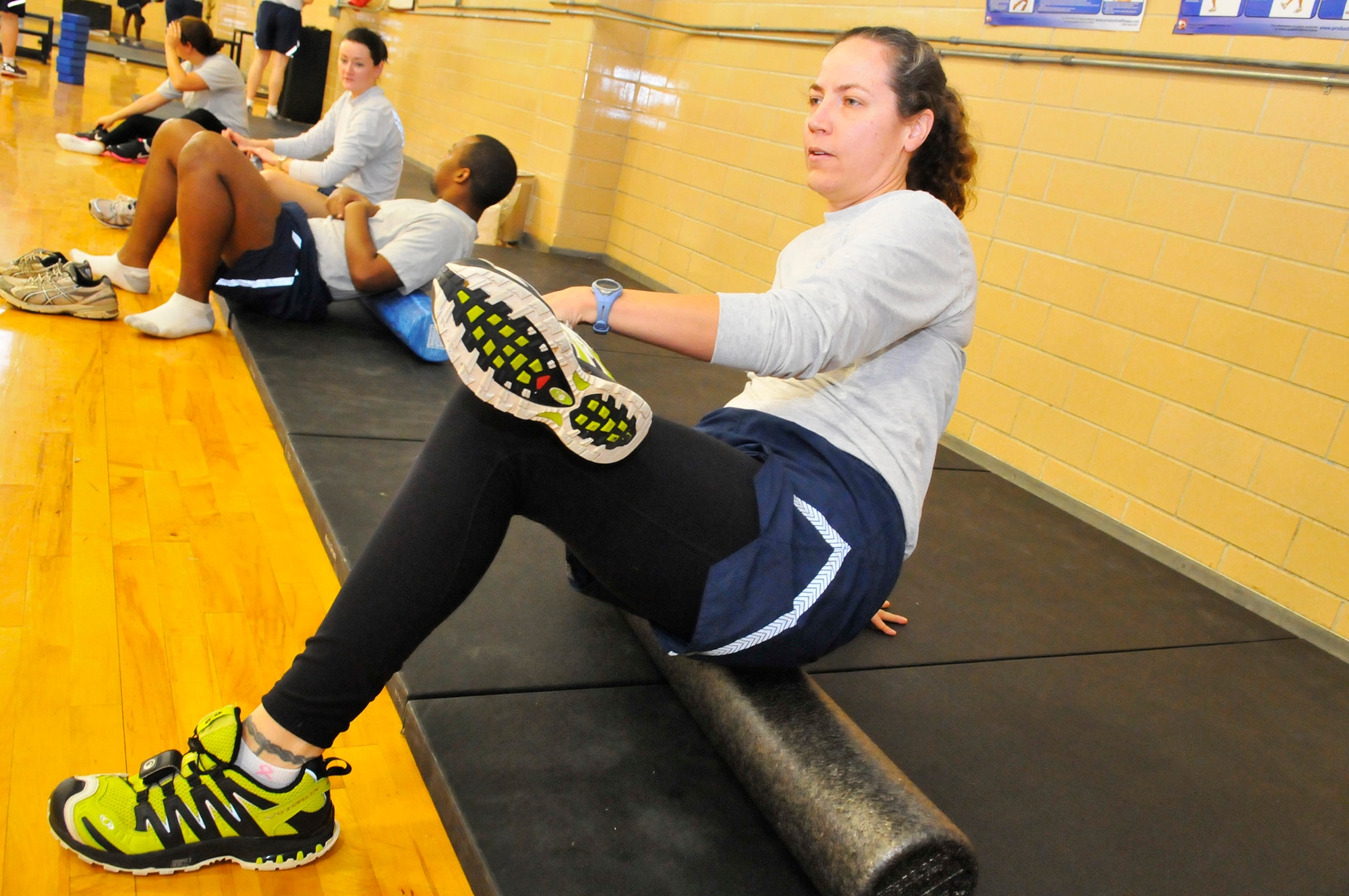 Tech. Sgt. Amy Moran stretches and warms up at a Total Force Fitness Program class. (U. S. Air Force photo by Sue Sapp)