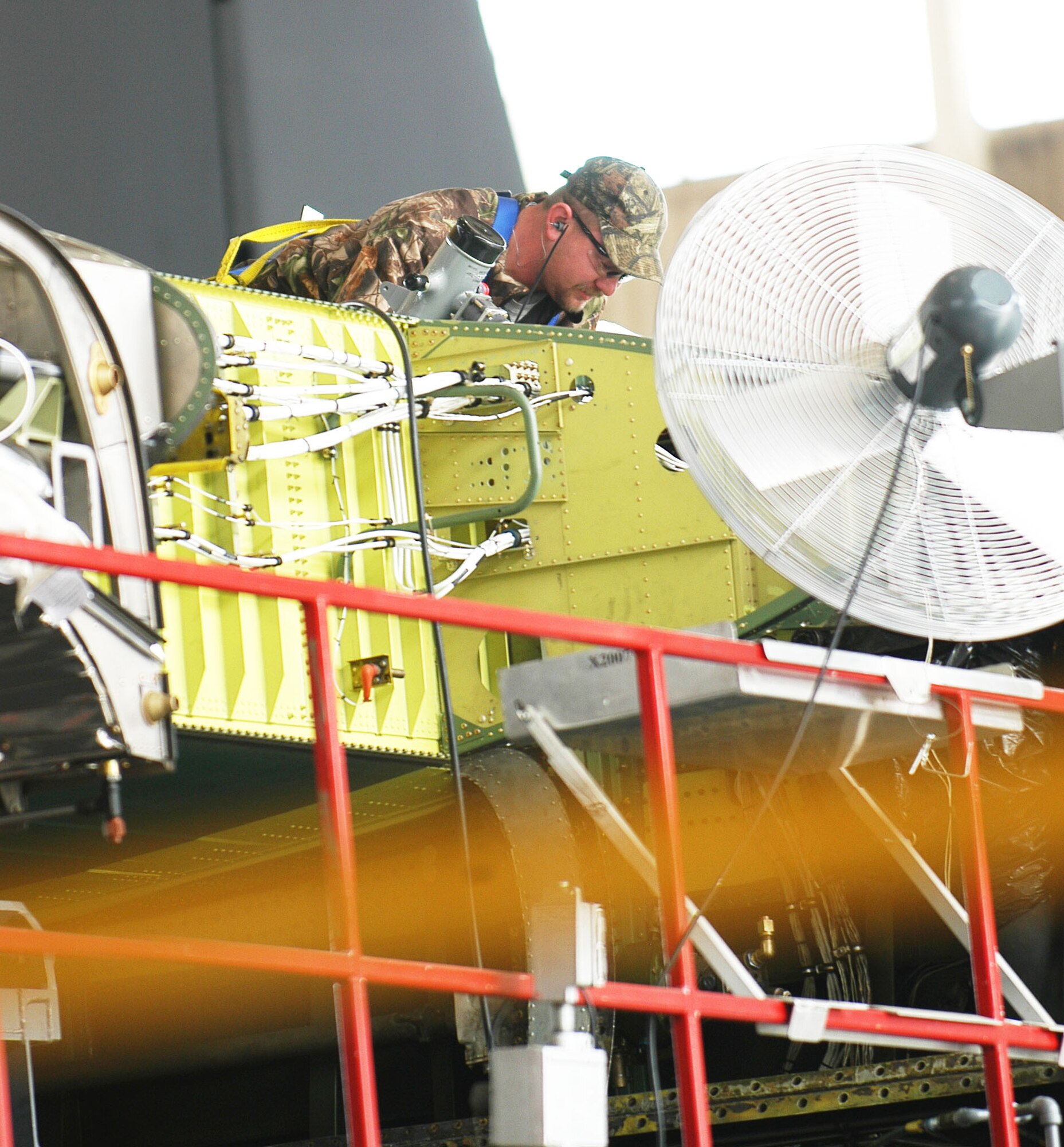 Thomas Long, aircraft mechanic, builds up the #5 dry bay on the replaced center wing box of the Coast Guard C-130 here at Robins. (U. S. Air Force photo by Sue Sapp)