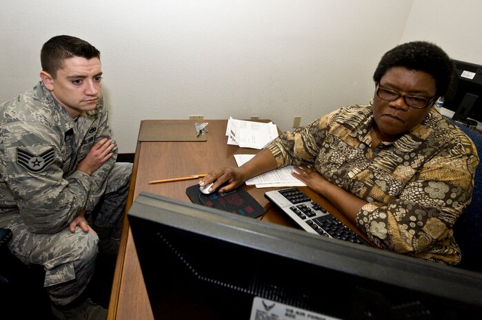 U.S. Air Force Staff Sgt. Richard Carver, 99th Logistics Readiness Squadron recruiter, reviews information with Betty Patrick, Base Tax Office volunteer, as she prepares his tax return March 13, 2012,  at Nellis Air Force Base, Nev. The Base Tax Office averages about 3,000 tax returns a year. (U.S. Air Force photo by Airman 1st Class Matthew Lancaster)