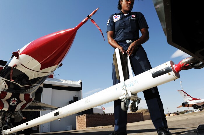 Staff Sgt. Tacota LeMuel, Thunderbird 3 dedicated crew chief, prepares to have her jet towed into the hangar after a training sortie at Nellis Air Force Base, Nev., March 6, 2012.
(U.S. Air Force photo/Staff Sgt. Larry E. Reid Jr., Released)
