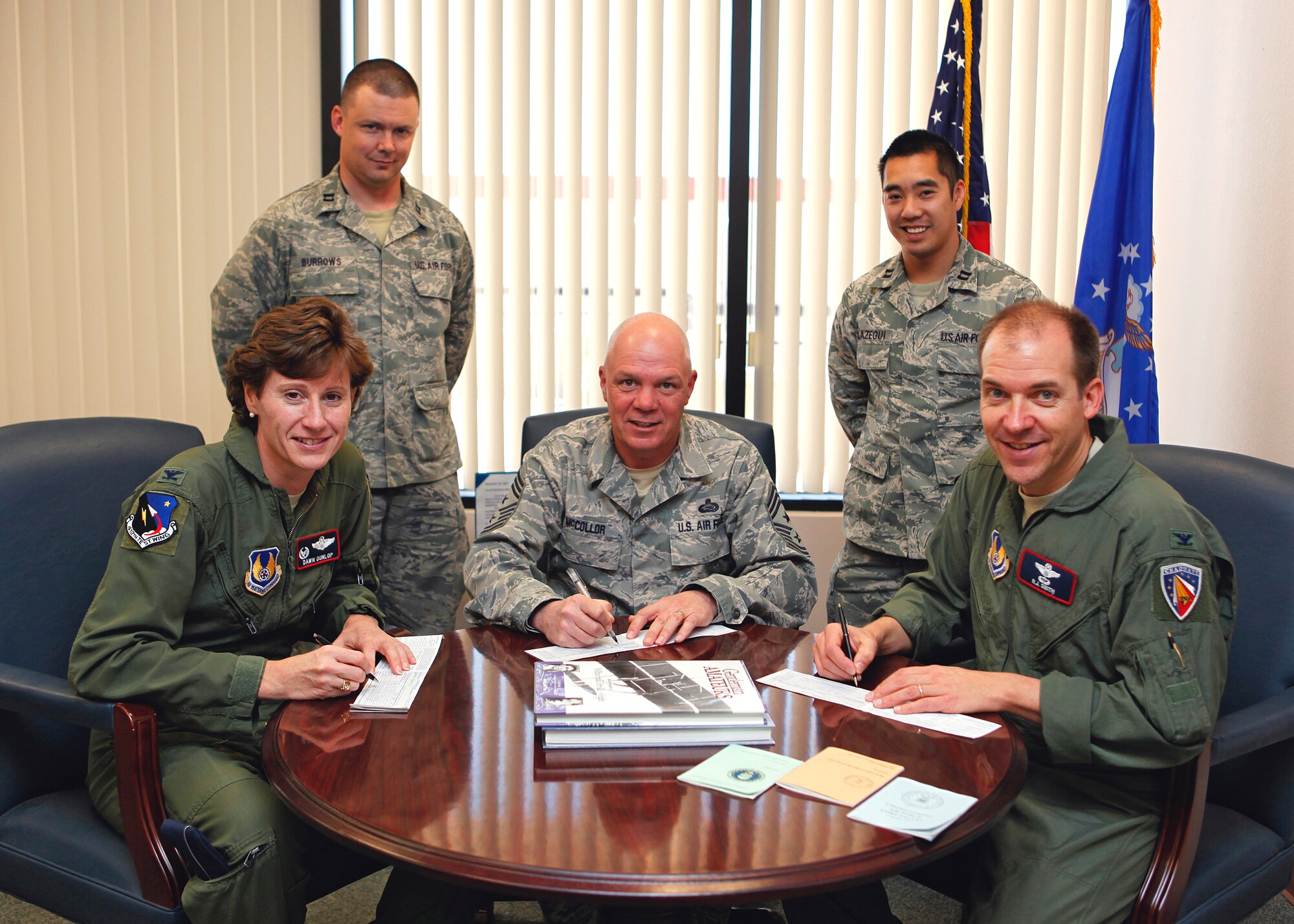 As part of the kick off for the Air Force Assistance Fund campaign, Col. Dawn Dunlop (from left), 412th Test Wing commander, Chief Master Sgt. Christopher McCollor, 412th TW command chief, and Col. Ryan Smith, 412th TW vice commander, take a moment to fill out their contribution forms March 8. This year's AFAF campaign continues the Air Force’s heritage of "Airmen taking care of Airmen" for the 39th year and will run from March 5 to April 13, 2012. (U.S. Air Force photo by Jet Fabara) 