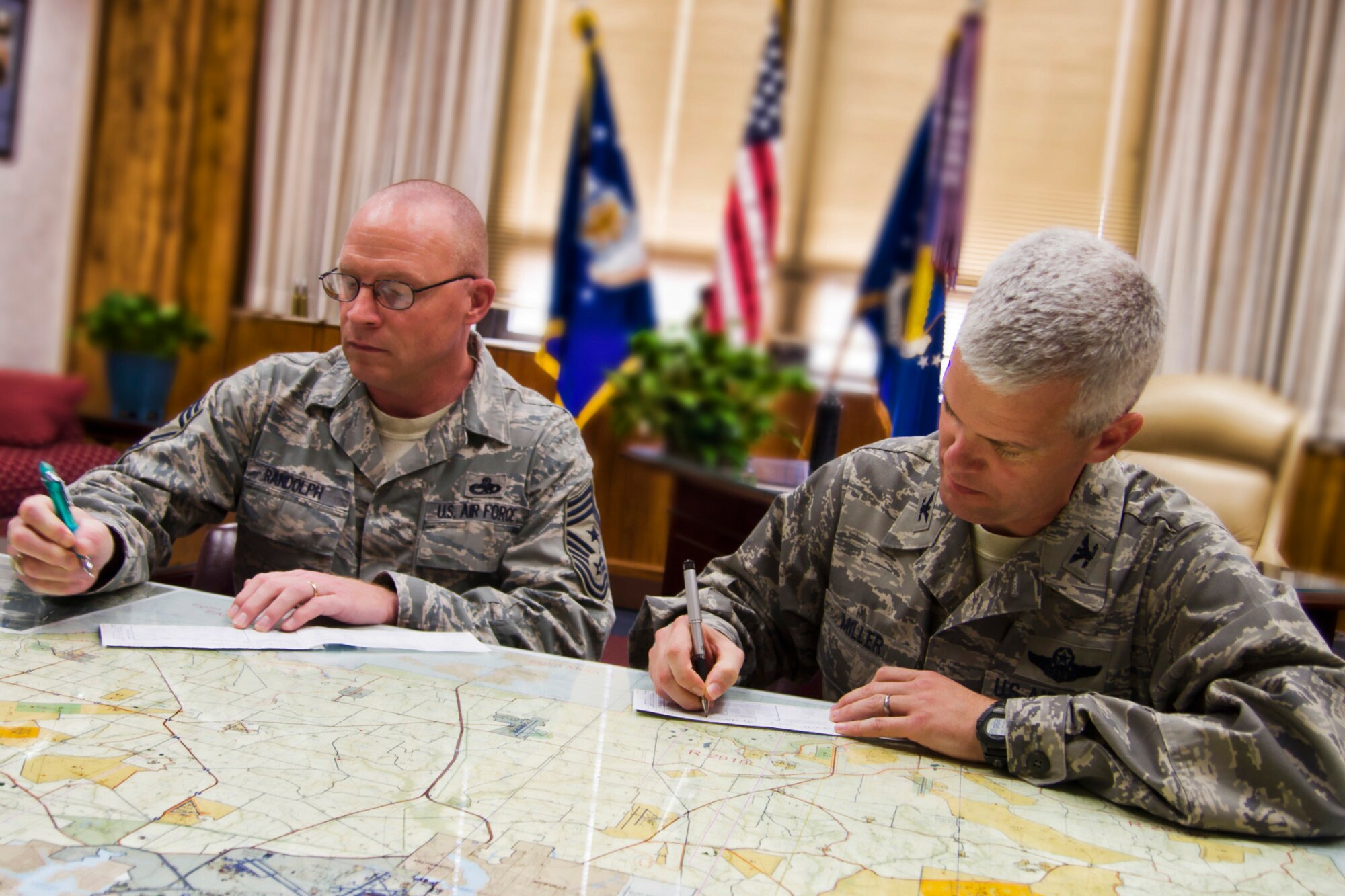 Chief Master Sgt. Brian Randolph, the 46th Test Wing command chief, and Col. Colin Miller, the 46th TW commander, complete their Air Force Assistance Fund forms at Eglin Air Force Base, Fla.  The deadline to donate for this year's campaign is March 16.  The 46th TW raised 124 percent of their goal contributing more than $22,000 to AFAF this year.  (Courtesy photo)