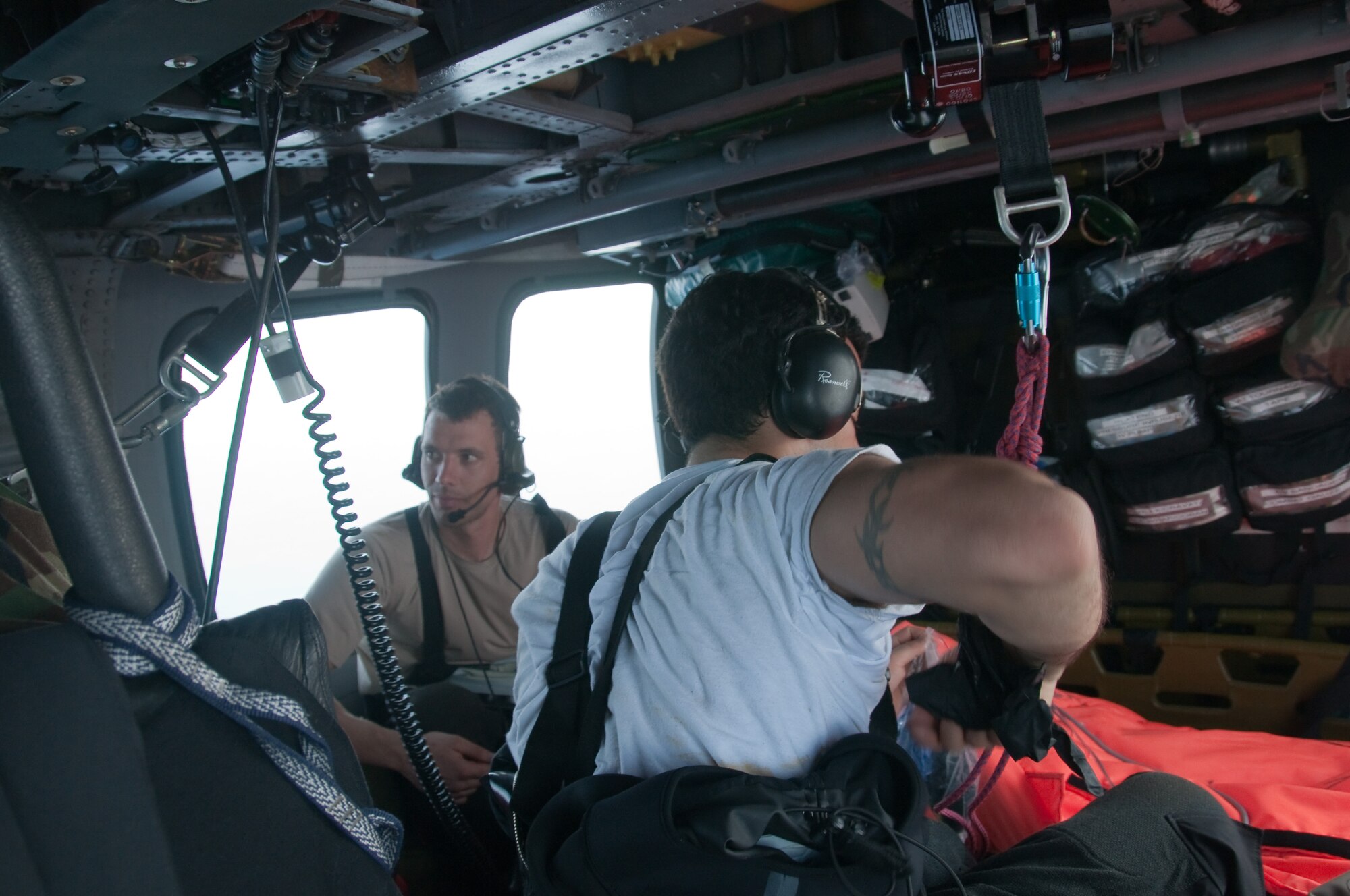 Pararescuemen from the 129th Rescue Wing provide medical treatment to an injured fisherman onboard an HH-60G Pave Hawk rescue helicopter, March 12, 2012. The PJs rescued two fishermen who were burned in a diesel fire onboard a Chinese vessel more than 700 miles off the coast of Acapulco, Mexico. (Air National Guard photo by Maj. Mat Wenthe)