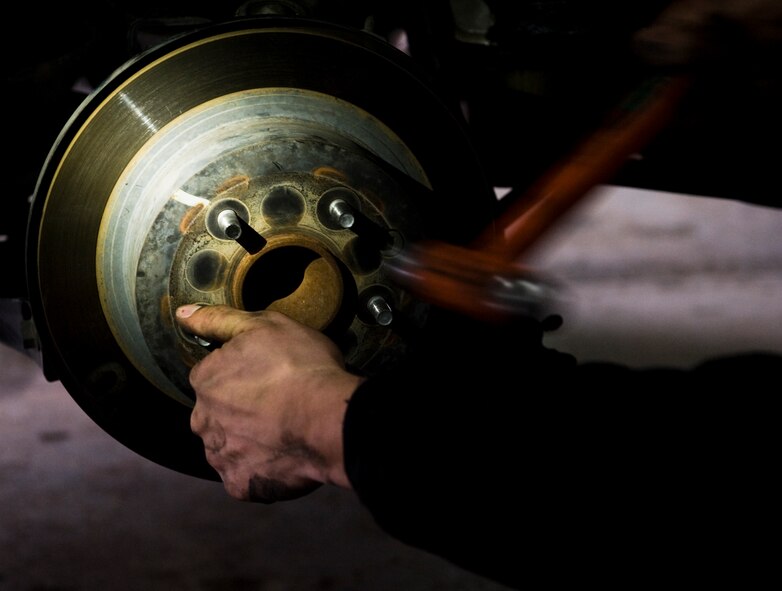 U.S. Air Force Staff Sgt. Timothy Crowsey, 7th Logistics Readiness Squadron, changes a rear rotor March 10, 2012, at Beltway Garage, in Abilene, Texas. Beltway Garage, a volunteer garage, is open on the first and third Saturday of every month from 9:00 a.m. to 12:00 p.m. Volunteers diagnose vehicles, change brakes, fix minor repairs and provide oil changes for the under privileged. (U.S. Air Force photo by Airman 1st Class Jonathan Stefanko/ Released)