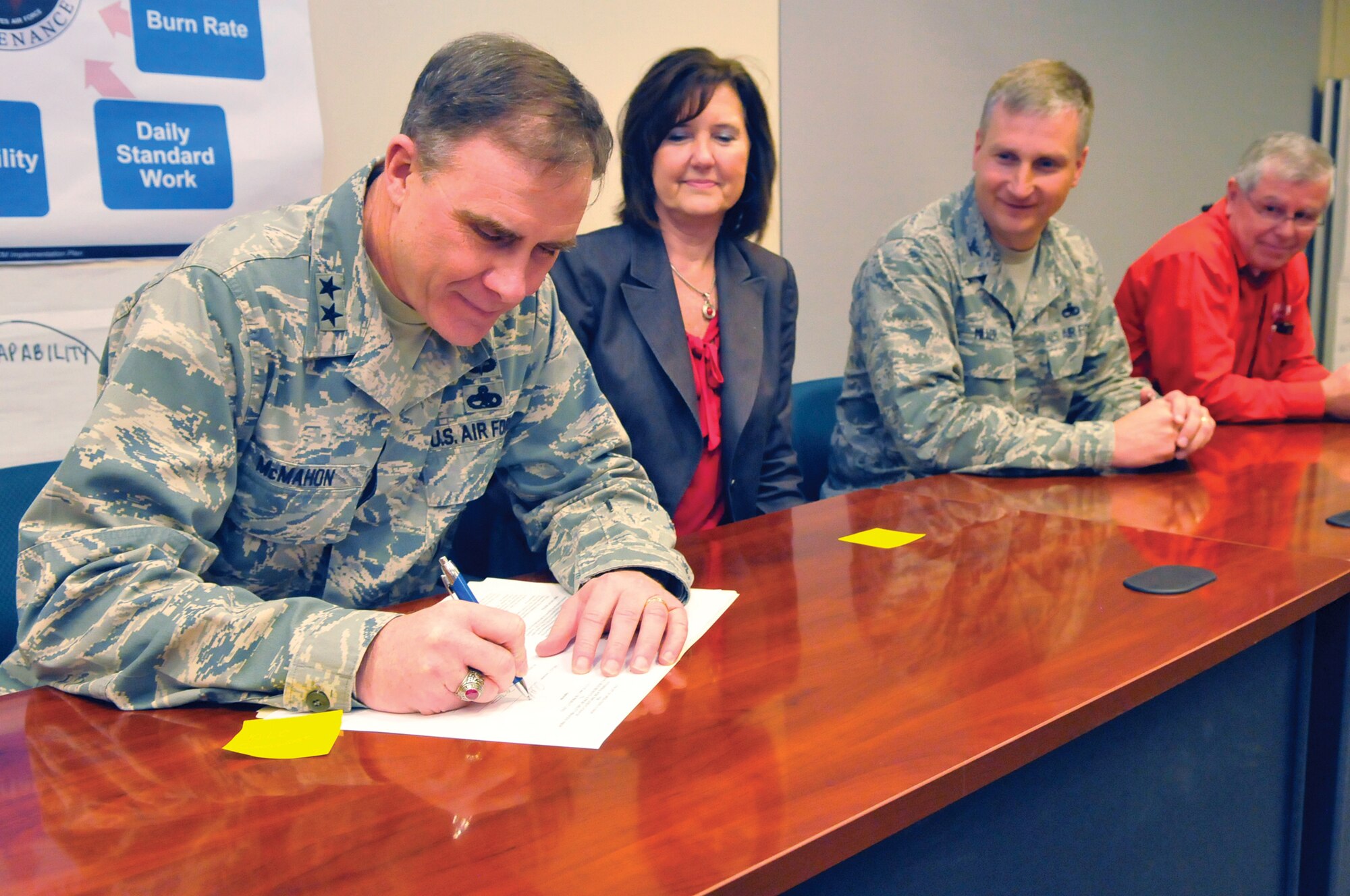 Maj. Gen. Bob McMahon, Warner Robins Air Logistics Center commander, signs an agreement after a Maintenance Requirements Supportability Value Stream Analysis event outbrief March 9. The agreement signifies a commitment to fully implement a Maintenance Requirements Supportability Process for four weapons systems: C-5, C-130, F-15 and C-17. (U. S. Air Force photo by Sue Sapp)
