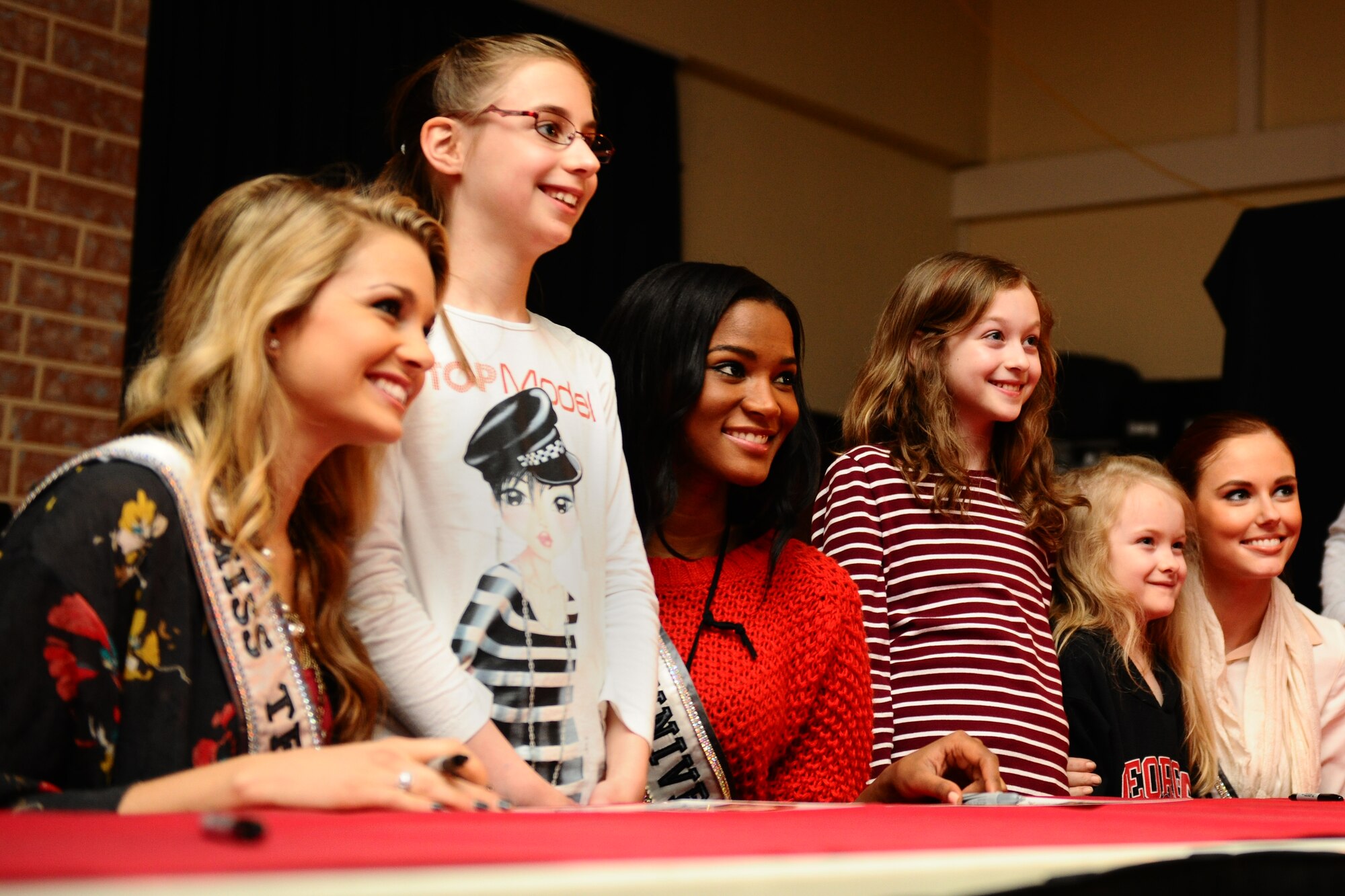 SPANGDAHLEM AIR BASE, Germany – Danielle Doty, Miss Teen USA 2011; Maren Thiel; Leila Lopez, Miss Universe 2011; Hannah Rice; Megan Rice; and Alyssa Campanella, Miss USA 2011, pose for a picture at the Brick House during their USO and Armed Forces Entertainment tour here March 13. The purpose of the tour was to boost morale and show support to U.S. service members and their families stationed in Germany. (U.S. Air Force photo by Airman 1st Class Matthew B. Fredericks/Released)