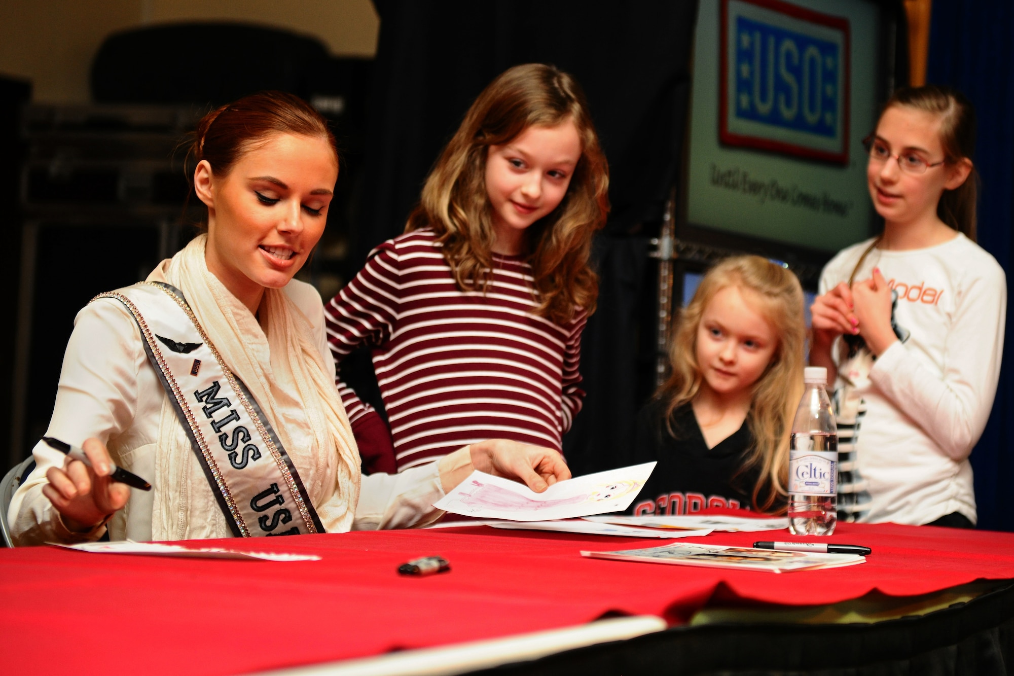 SPANGDAHLEM AIR BASE, Germany – Alyssa Campanella, Miss USA 2011, autographs pictures for, from right, Maren Thiel, daughter of Tina Thiel; and Megan Rice and Hannah Rice, daughters of Andrew Rice, 52nd Force Support Squadron, during a USO and Armed Forces Entertainment tour at the Brick House here March 13. The purpose of the tour was to boost morale and show support to U.S. service members and their families stationed in Germany. (U.S. Air Force photo by Airman 1st Class Matthew B. Fredericks/Released)