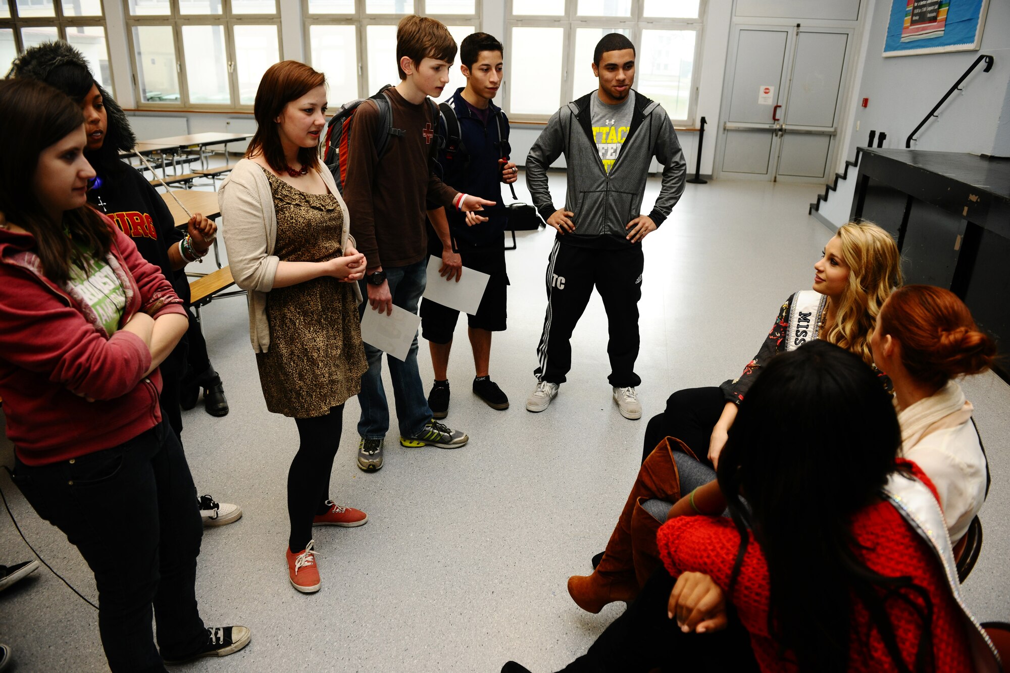 BITBURG ANNEX, Germany –Danielle Doty, Miss Teen USA 2011, left; Alyssa Campanella, Miss USA 2011, middle; and Leila Lopez, Miss Universe 2011 talk with students while visiting Bitburg High School during their USO and Armed Forces Entertainment tour here March 13. The purpose of the tour was to boost morale and show support to U.S. service members and their families stationed in Germany. (U.S. Air Force photo by Airman 1st Class Matthew B. Fredericks/Released)