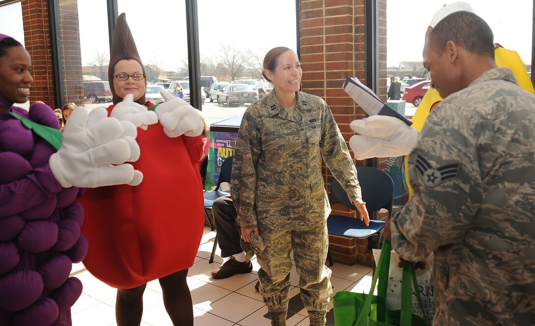 Airmen from the 633rd Medical Support Squadron Nutritional Medicine Flight quiz Capt. Coulette Swiggett, Air Combat Command force support officer, at Langley Air Force Base, Va., Mar. 13, 2012.  The Airmen quizzed and informed Langley personnel about good nutrition and healthy living in support of National Nutrition Month. (U.S. Air Force photo by Staff Sgt. Antoinette Gibson/Released)