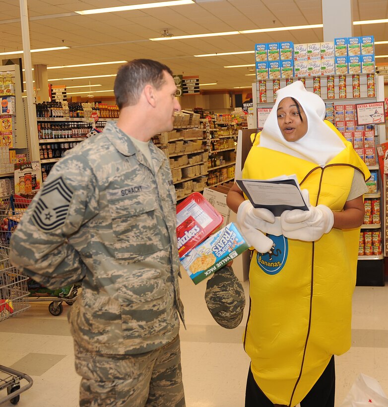 Senior Airman Taylor Simon, 633rd Medical Support Squadron diet therapist, shares nutritional information with Chief Master Sgt. Robert Schacht, 192nd Fighter Wing superintendant, during National Nutrition Month at the commissary at Langley Air Force Base, Va., Mar. 13, 2012. Health professionals use National Nutrition Month to focus attention on the importance of making informed food choices and developing sound eating and physical activity habits. (U.S. Air Force photo by Staff Sgt. Antoinette Gibson/Released)

