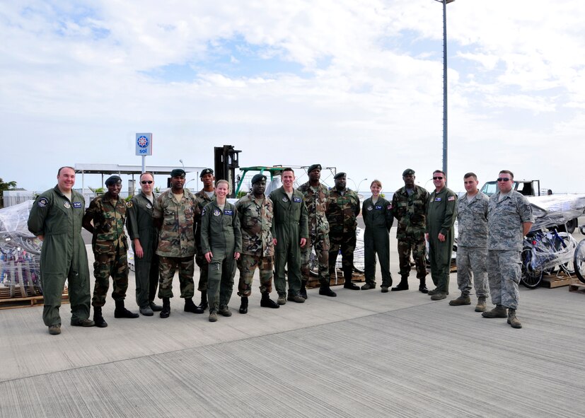 Several members of the 914th Airlift Wing pose with St. Kitts military in front of donated Denton Program cargo March 10, 2012, St. Kitts, Eastern Caribbean. The Denton Program was designed to allow private U.S. citizens and organizations to use space available on military cargo planes to transport humanitarian goods such as food, clothing, medical supplies, educational supplies and vehicles to countries in need. (U.S. Air Force photo By Tech Sgt. Joseph McKee)