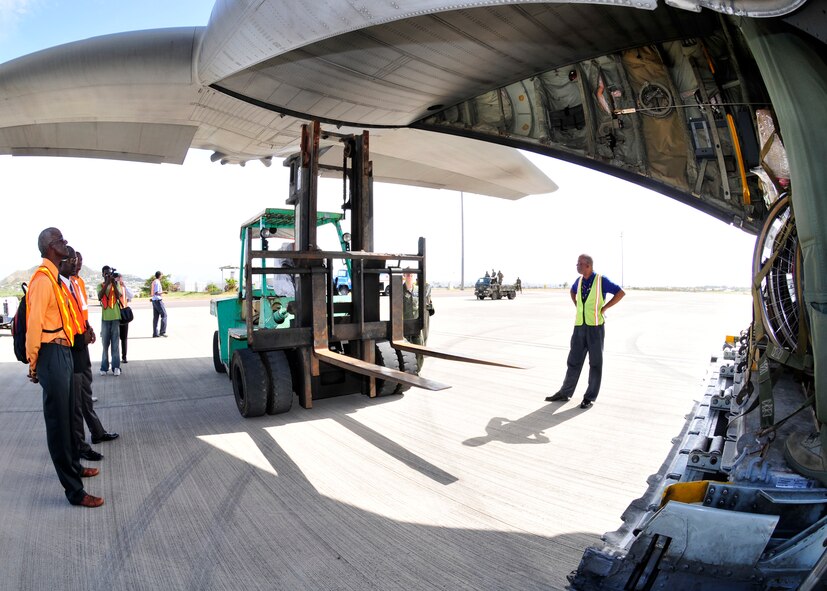 Medical supplies and other items donated to the Denton Program are unloaded from a 914th Airlift Wing C-130 March 10, 2012, St. Kitts, Eastern Caribbean. The Denton Program was designed to allow private U.S. citizens and organizations to use space available on military cargo planes to transport humanitarian goods such as food, clothing, medical supplies, educational supplies and vehicles to countries in need. (U.S. Air Force photo by Tech Sgt. Joseph McKee) 