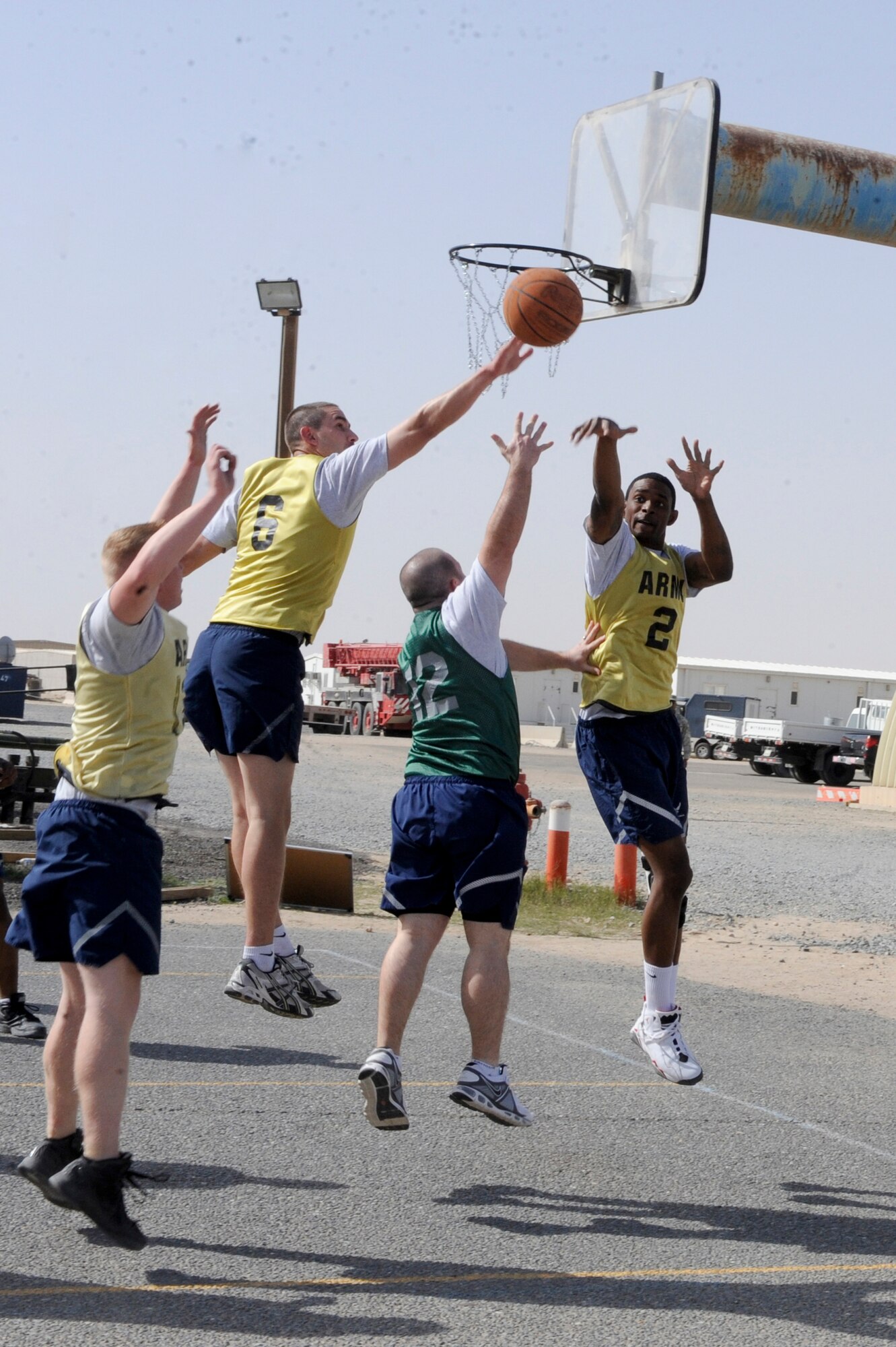 Staff Sgt. Sean O'Hagan, 332nd Force Support Squadron member, makes a layup while three defenders from the 332nd Security Forces Squadron attempt to block his shot during an intramural basketball game at an undisclosed location in Southwest Asia, March 9, 2012. O'Hagan is deployed from Luke Air Force Base, Ariz., and is a native of Rancho Bernado, Calif. (U.S. Air Force photo by Staff Sgt. Joshua J. Garcia/Released)