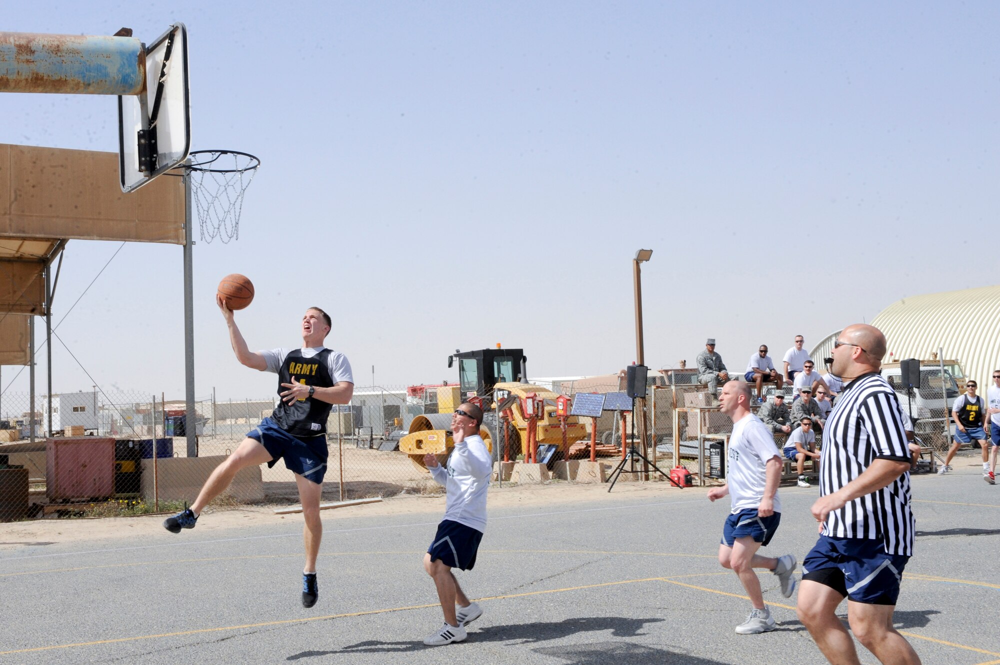 Airman 1st Class Ryan West, 332nd Expeditionary Civil Readiness Squadron member, attempts a layup during an intramural basketball game at an undisclosed location in Southwest Asia, March 9, 2012. West played on an all firefighter team during the game. West is deployed from Seymour Johnson Air Force Base, N.C. (U.S. Air Force photo by Staff Sgt. Joshua J. Garcia/Released)