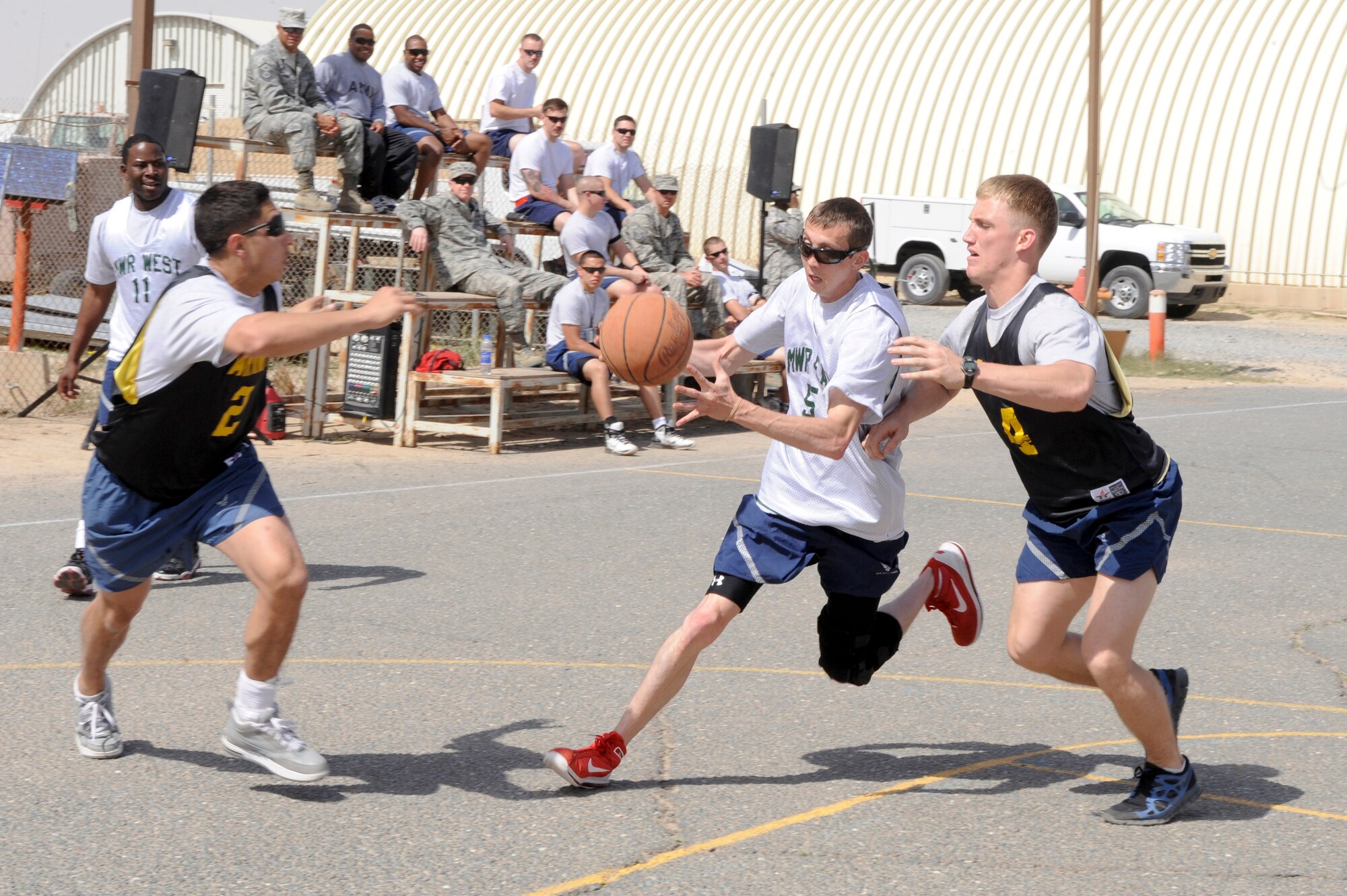 Staff Sgt. Dallas Mason, 332nd Expeditionary Logistics Readiness Squadron member, drives the ball to the hoop during an intramural basketball game at an undisclosed location in Southwest Asia, March 9, 2012. Following the basketball season an intramural volleyball season will be offered to wing members. Mason is deployed from Joint Base Langley-Eustis, Va., and is a native of Corbin, Ky. (U.S. Air Force photo by Staff Sgt. Joshua J. Garcia/Released)