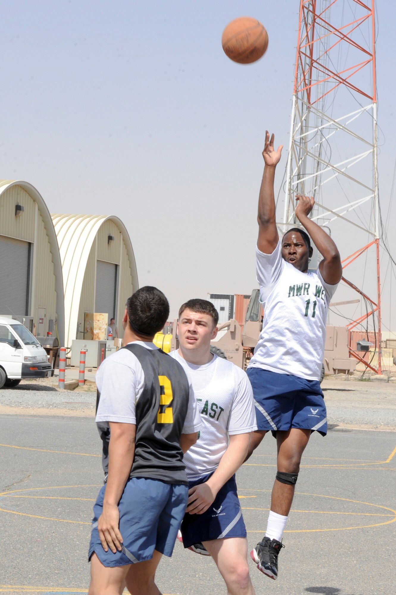 Staff Sgt. Derrick Bradford, 332nd Expeditionary Logistics Readiness Squadron member, shoots a 3-point jump shot during an intramural basketball game at an undisclosed location in Southwest Asia, March 9, 2012. Basketball is the first intramural season offered to 332nd Air Expeditionary Wing members. Bradford is deployed from Aviano Air Base, Italy, and is a native of Memphis, Tenn. (U.S. Air Force photo by Staff Sgt. Joshua J. Garcia/Released)