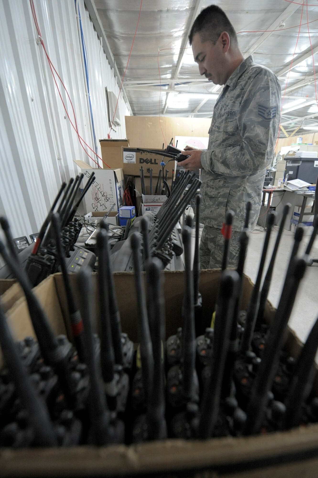 Staff Sgt. Michael Durch, 332nd Expeditionary Communication Squadron operations flight member, re-keys land mobile radios at an undisclosed location in Southwest Asia, March 13, 2012. The operations flight handles all means of communication to include computers, land mobile radios and cell phones. Durch is deployed with the Hawaii Air National Guard, and is a native of Hilo, Hawaii. (U.S. Air Force photo by Staff Sgt. Joshua J. Garcia)
