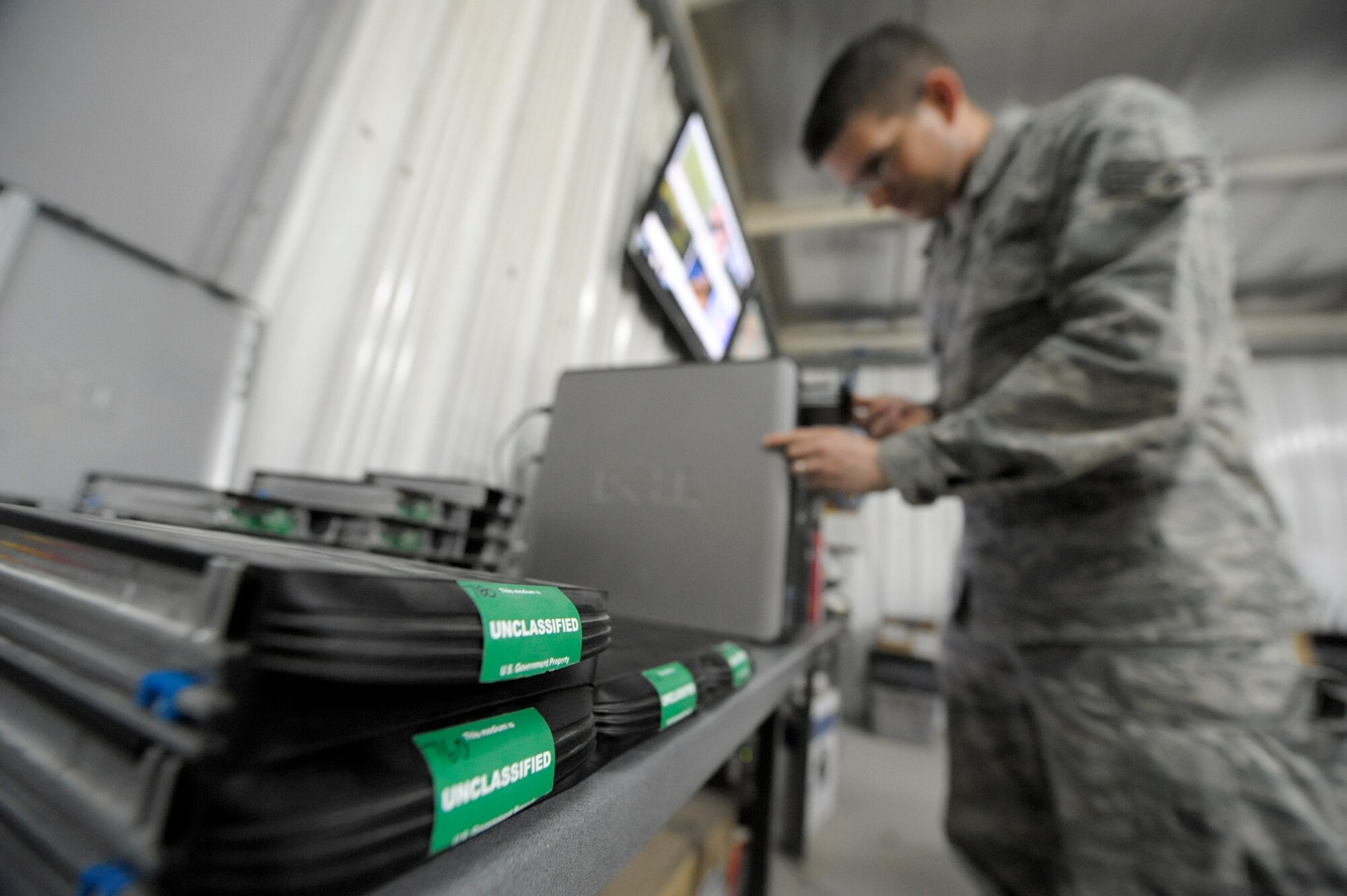 Senior Airman Cody Hill, 332nd Expeditionary Communication Squadron operations flight member, reimages unclassified hard drives at an undisclosed location in Southwest Asia, March 12, 2012. Reimaging automatically installs all the programs associated with the Air Force's standard desktop configuration. Hill is deployed from Ramstein Air Base, Germany, and is a native of Van Alstyne, Texas. (U.S. Air Force photo by Staff Sgt. Joshua J. Garcia)