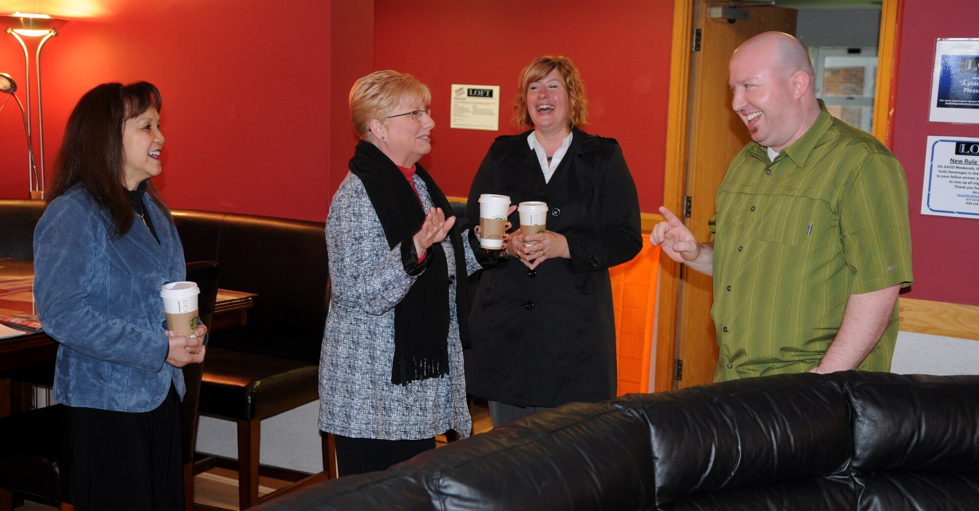 RAF MILDENHALL, England – Paula Roy (front center), wife of Chief Master Sgt. of the Air Force James Roy, jokes with Micah Steinwandt, right, RAF Mildenhall Single Airman’s Ministry director, during a visit to the SAM’s Loft facility here March 13, 2012. Roy was briefed by Steinwandt, as well as Airmen involved with the SAM. (U.S. Air Force photo/Staff Sgt. Austin M. May)