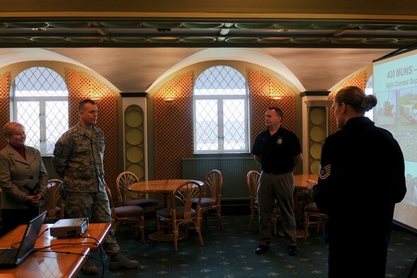 RAF CROUGHTON, United Kingdom - Tech. Sgt. Susan Erdrich, 420th Munitions Squadron, and Tim Hershberger, 420th Air Base Squadron, brief Chief Master Sgt. of the Air Force James Roy, and his wife, Paula, at the RAF Fairford Dining Facility March 12. Erdrich and Hershberger spoke about the support their units provide to enable global strike operations at RAF Fairford and munitions storage at RAF Welford. (U.S. Air Force photo by Staff Sgt. Autumn Bogert)