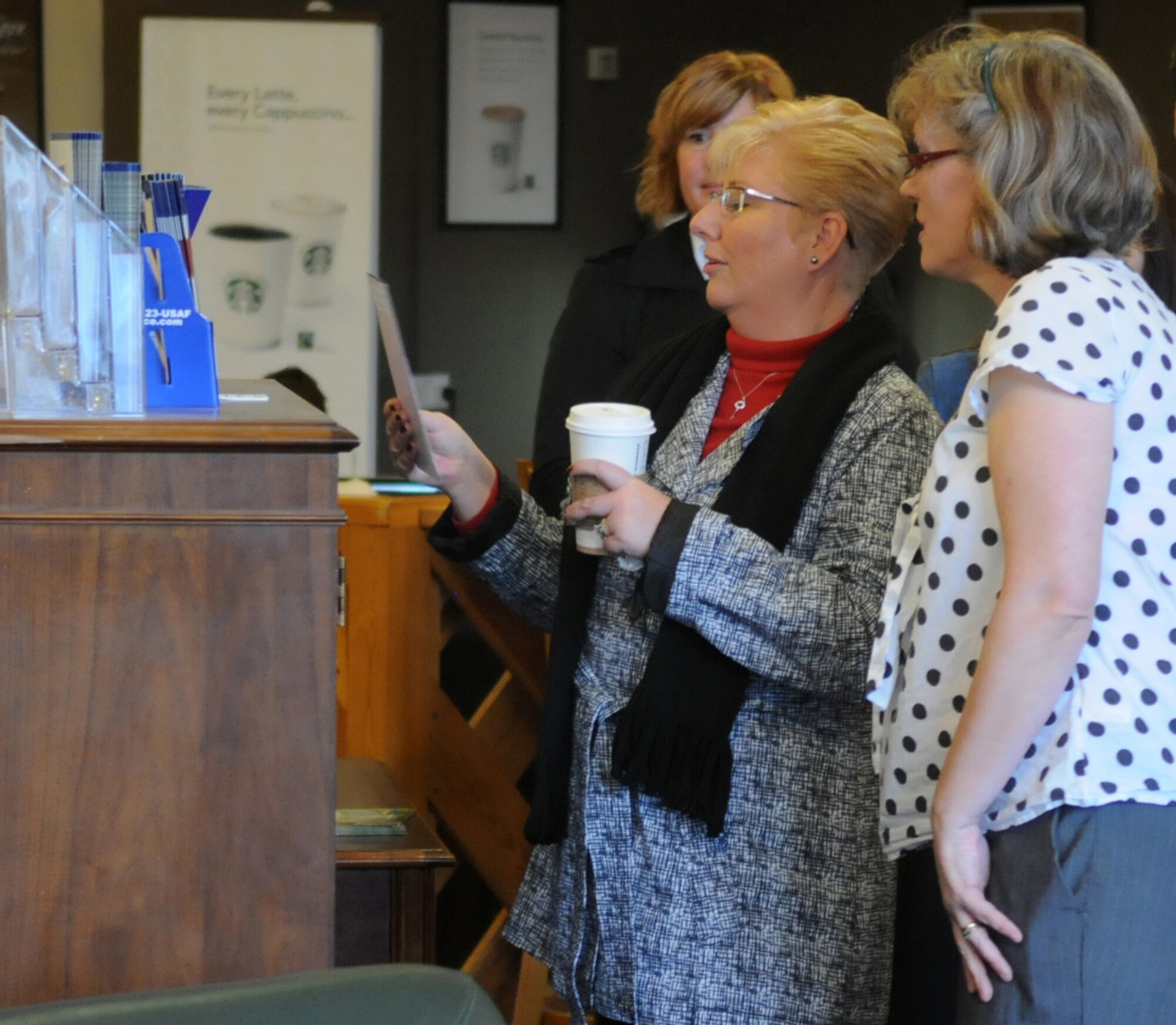 RAF MILDENHALL, England – Paula Roy (front left), wife of Chief Master Sgt. of the Air Force James Roy, looks over various programs offered by the 100th Force Support Squadron while Stephanie Lown, Bob Hope Community Center Director, explains the purpose of each one during a visit to the facility here March 13, 2012. Roy accompanied her husband during site visits to RAF Mildenhall and RAF Lakenheath, touring various support facilities and discussing their effectiveness with program directors. (U.S. Air Force photo/Staff Sgt. Austin M. May)
