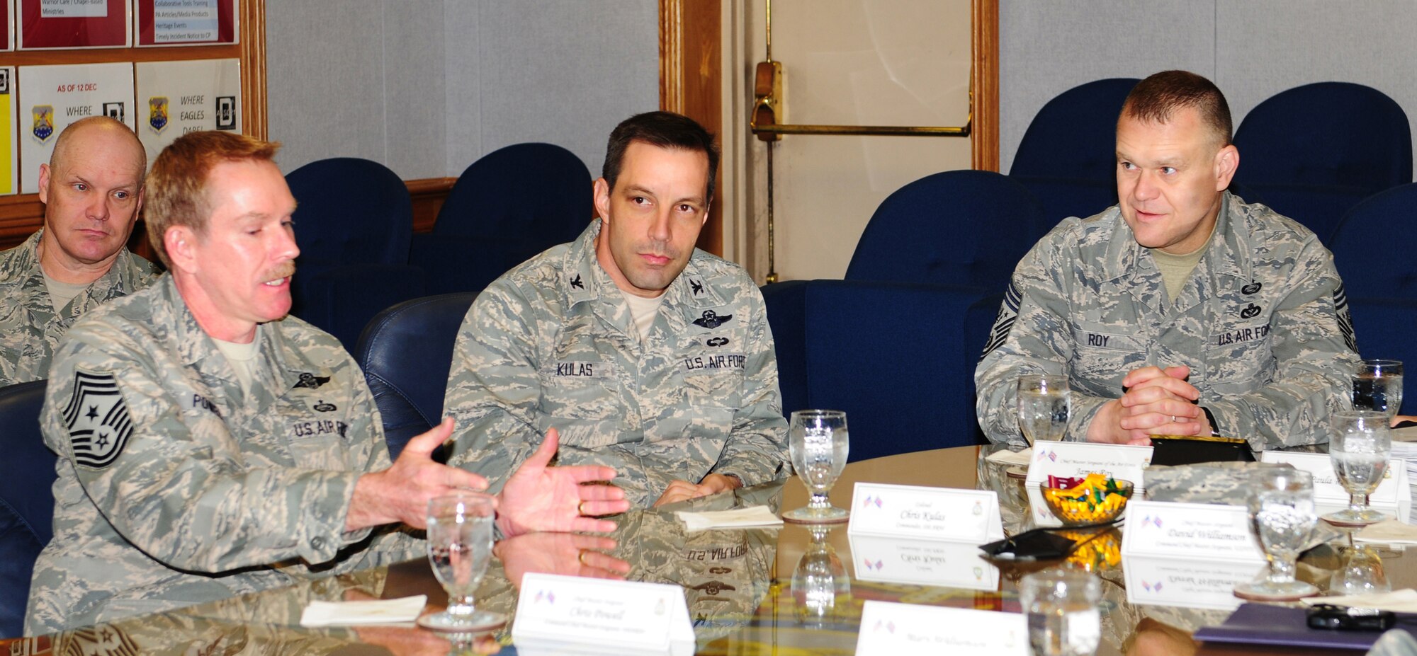 RAF MILDENHALL, England -- Chief Master Sgt. Christopher Powell, 100th Air Refueling Wing command chief, explains to Chief Master Sgt. of the Air Force James Roy, right, how the upcoming International Tanker Symposium in May will build partnerships between the U.S. Air Force and several European nations, during a wing mission brief with Col. Christopher Kulas, 100th ARW commander, at wing headquarters here March 13, 2012. Roy conducted site visits, addressing first-line supervisors and company grade officer supervisors, as well as meeting wing leadership. He also visited nearby RAF Lakenheath and held an all call, which was attended by military members from both bases. (U.S. Air Force photo/Karen Abeyasekere)