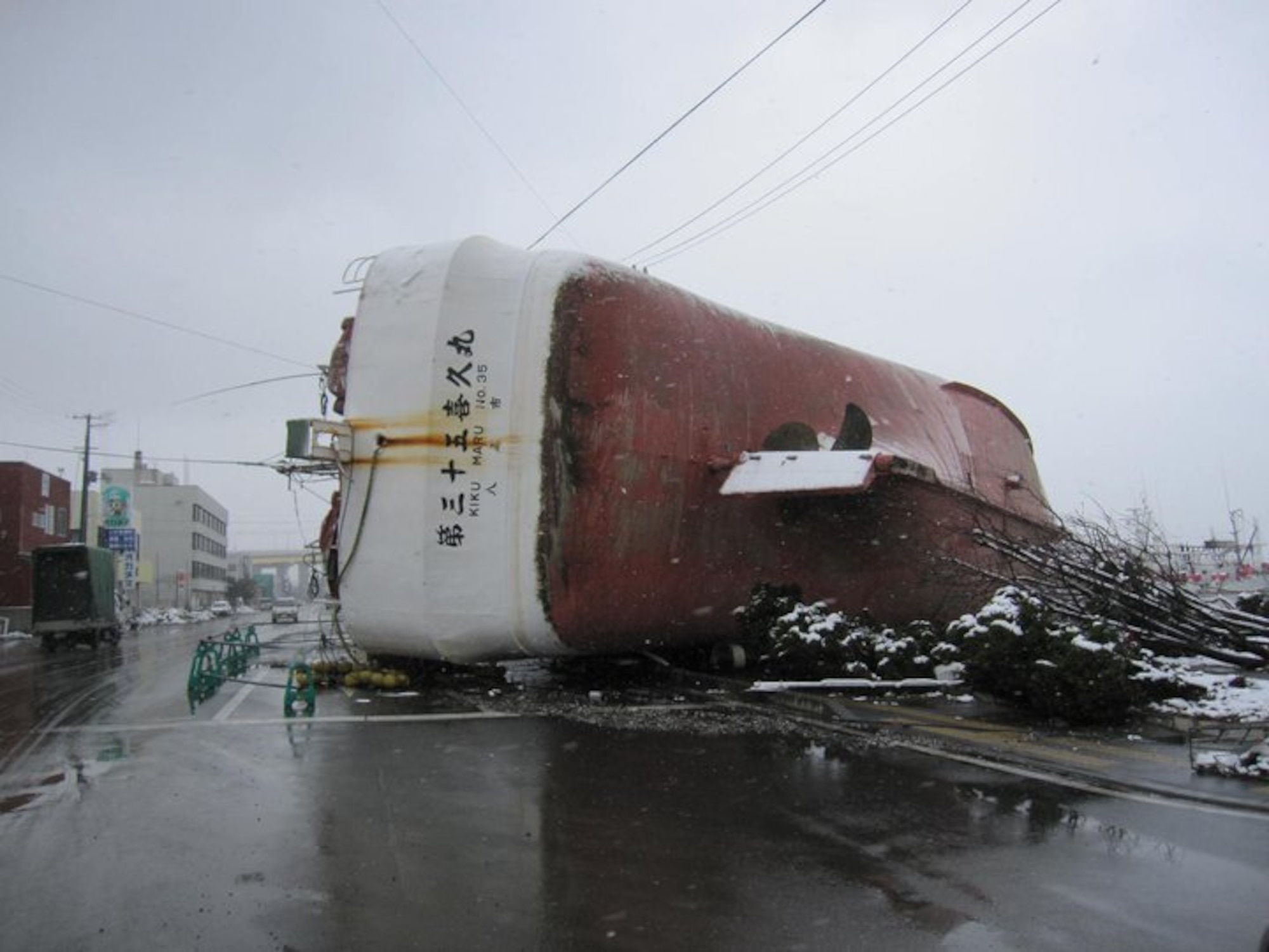 The fishing boat, Kiku Maru No. 35, lies on its side in the middle of a street March 16, 2011, in Hachinohe City, Japan after a massive earthquake and tsunami hit the northeast coast. Hachinohe City was one of many areas where service members, dependents and civilians from Misawa Air Base, Japan volunteered cleanup and recover efforts. (courtesy photo) 