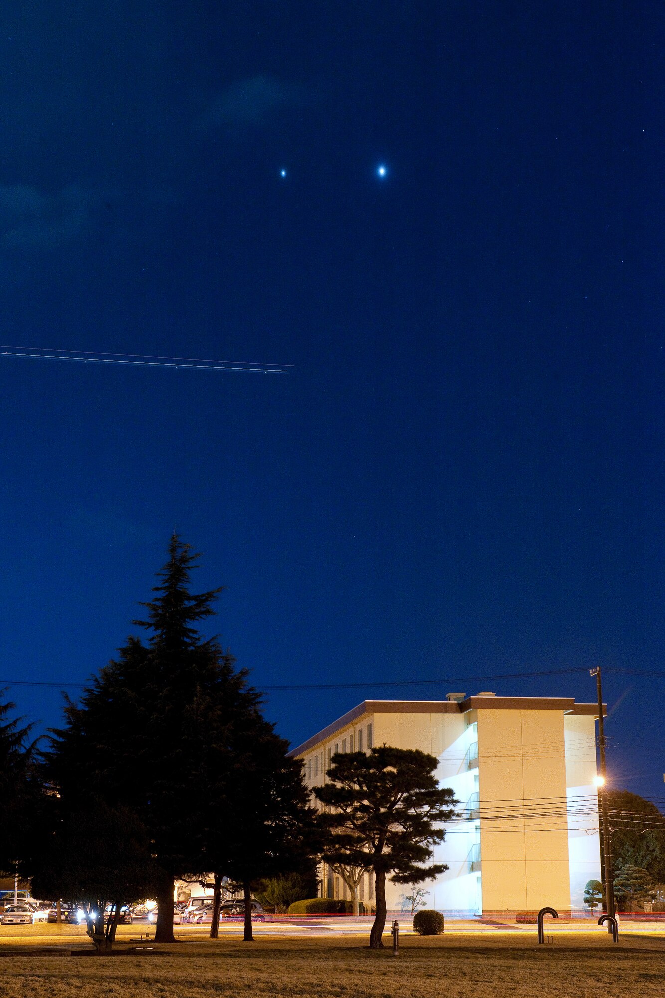 YOKOTA AIR BASE, Japan -- The brightest and second-brightest planets, Venus (right) and Jupiter come together for a stunning conjunction March 13, 2012, at Yokota Air Base, Japan.  A conjunction occurs when two or more plants appear close together in the sky. Although it may look like a shooting star the streak in the center of the photo is actually a C-130 Hercules photographed using an eight second time exposure. (U.S. Air Force photo/Osakabe Yasuo)