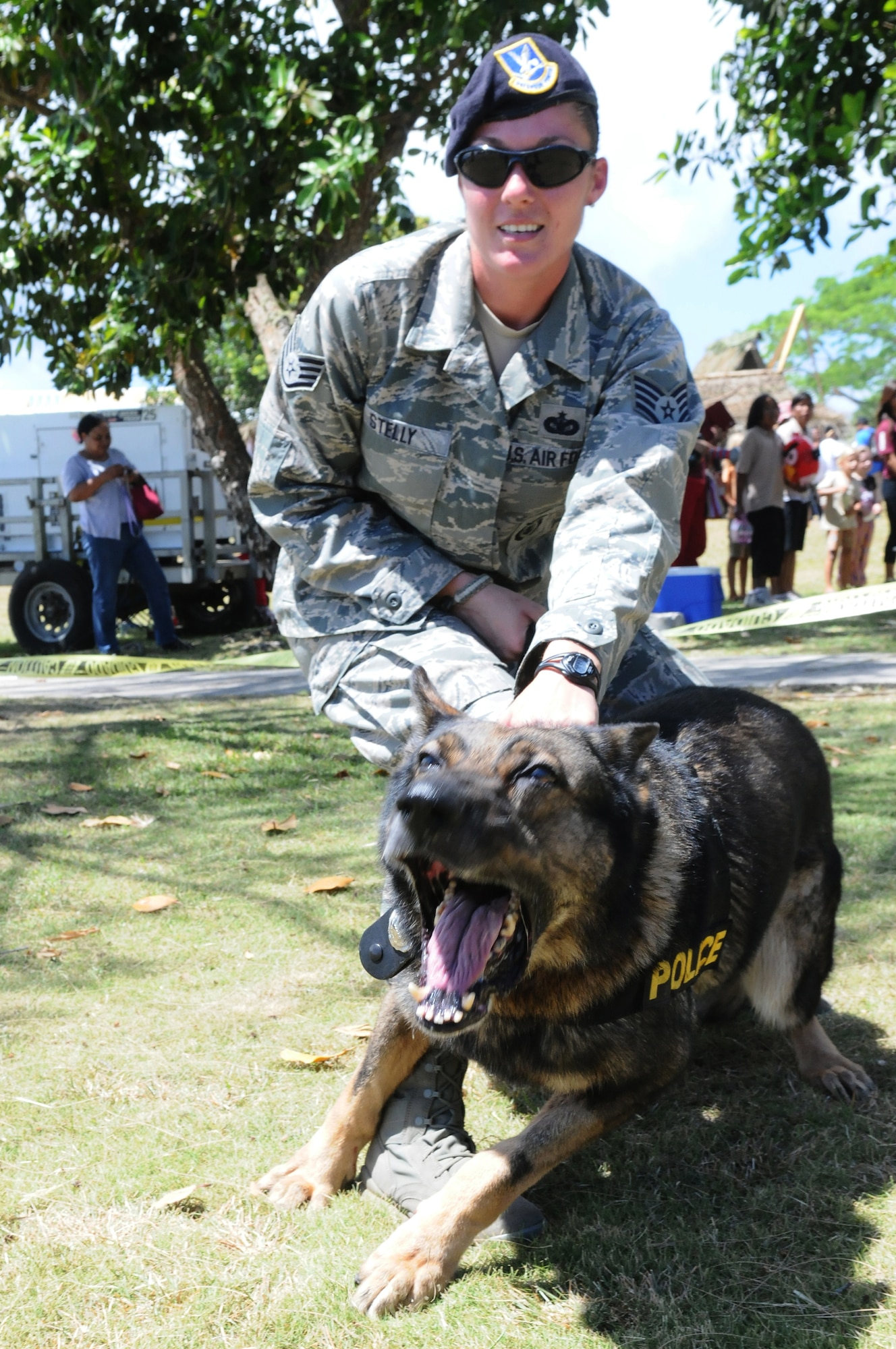 ANDERSEN AIR FORCE BASE, Guam - Staff Sgt. Tina Stelly, 36th Security Forces Squadron military working dog handler, holds back Mike, a military working dog, March 13. Sergeant Stelly and Mike are at University of Guam Charter day, performing dog handling demonstrations for the public. (U.S. Air Force photo/Senior Airman Carlin Leslie)
