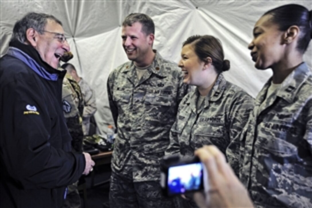 U.S. Defense Secretary Leon E. Panetta shares a laugh with U.S. Air Force Maj. Brian Miller, left,
Capt. Holly Gebert, center and Capt. Kay Stern, right, during a visit to the Transit Center at Manas, Kyrgyzstan, March 14, 2012. Miller, Gebert, and Stern are assigned to the Transit Centers Theater Security Cooperation Division.