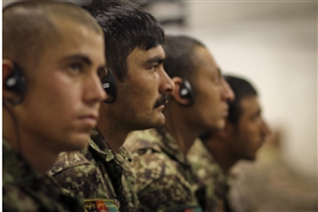 Afghan soldiers listen via translators to U.S. Defense Secretary Leon E. Panetta's speech at a town hall meeting on Camp Leatherneck, Afghanistan, March 14, 2012. Panetta spoke to more than 200 U.S., Afghan and coalition troops during the visit. 