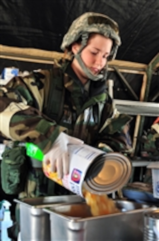 U.S. Air Force Airman 1st Class Kristen Patterson, with the 140th Force Support Squadron, prepares food to be served at a simulated deployed single pallet expeditionary kitchen during an operational readiness exercise at Buckley Air Force Base, Colo., on March 10, 2012.  National Guardsmen also participated in the exercise to prepare for deployments as well as an operational readiness inspection.  