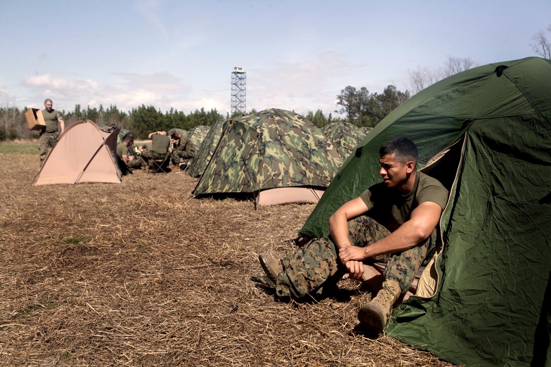 Sgt. Adolfo Aparicio, from Thousand Oaks, Calif., with Production and Analysis Support Company, 2nd Intelligence Battalion, II Marine Expeditionary Force, takes a break between training at the Counter Improvised Explosive Device Lane, March 8. The training provided intelligence analysts with an up close and personnel look at life on the ground while deployed, with the intent of giving the participants a better sense of perspective and understanding while interpreting raw intelligence information during their upcoming deployment.