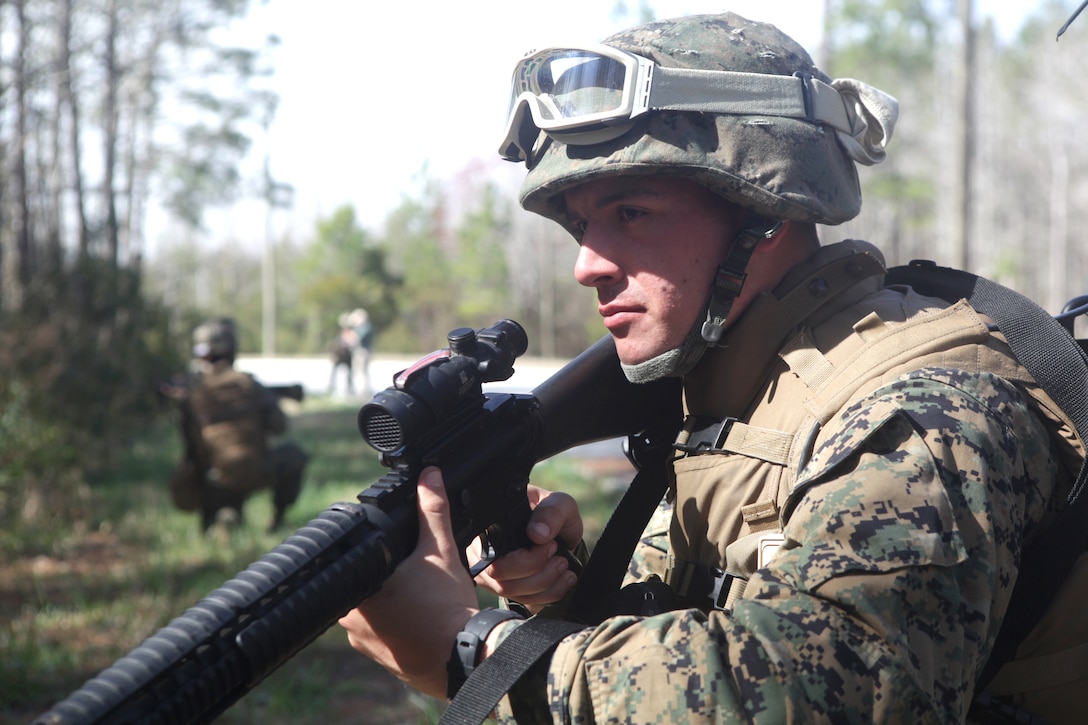 Lance Cpl. Alex Voultos, an intelligence specialist, from Detroit, Mich., serving with Production and Analysis Support Company, 2nd Intelligence Battalion, II Marine Expeditionary Force, provides security during the Counter Improvised Explosive Device Lane, March 8. The training provided intelligence analysts with an up close and personnel look at life on the ground while deployed, with the intent of giving the participants a better sense of perspective and understanding while interpreting raw intelligence information during their upcoming deployment.