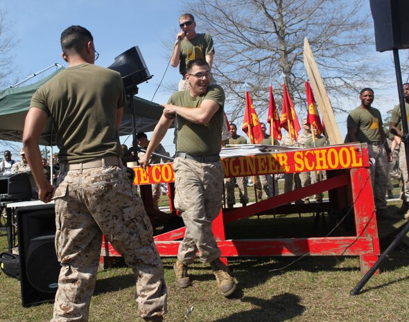 Two Marines dance while another sings during "Engineer Idol," one of over a dozen events held during the annual Saint Patrick’s Day Field Meet on Ellis Field in Courthouse Bay, March 15, aboard Marine Corps Base Camp Lejeune. The Marines jumped in to assist a Marine from their unit who was singing karaoke. ::r::::n::::r::::n::